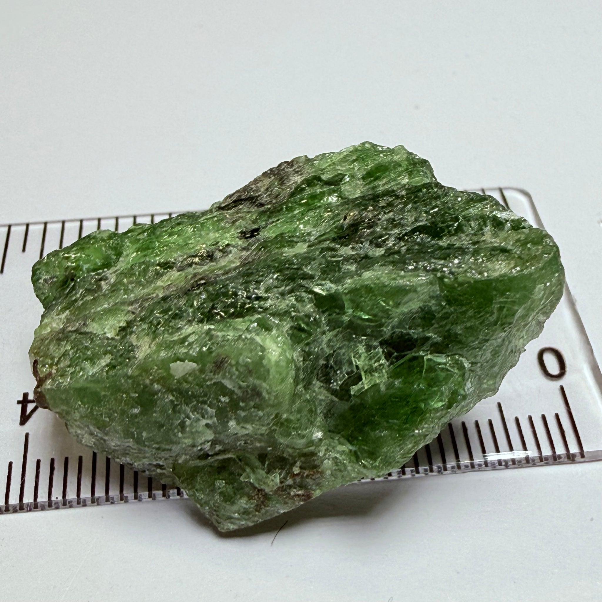 Tsavorite Crystal, 19.90gm / 99.50ct, Merelani. Tanzania, only the front is crystalized, but make a great specimen or set it in jewellery as is
