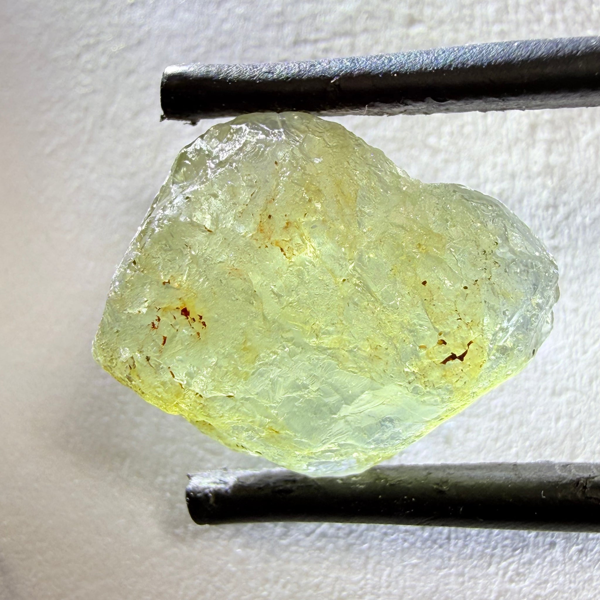 Umba Sapphire, 14.72ct, Umba Valley, Tanzania, Untreated Unheated. Slightly to moderately included,  slight silk, crack going a 1/4 way in. See the backlit pics  I have circled the crack, minor fissures to be removed before faceting