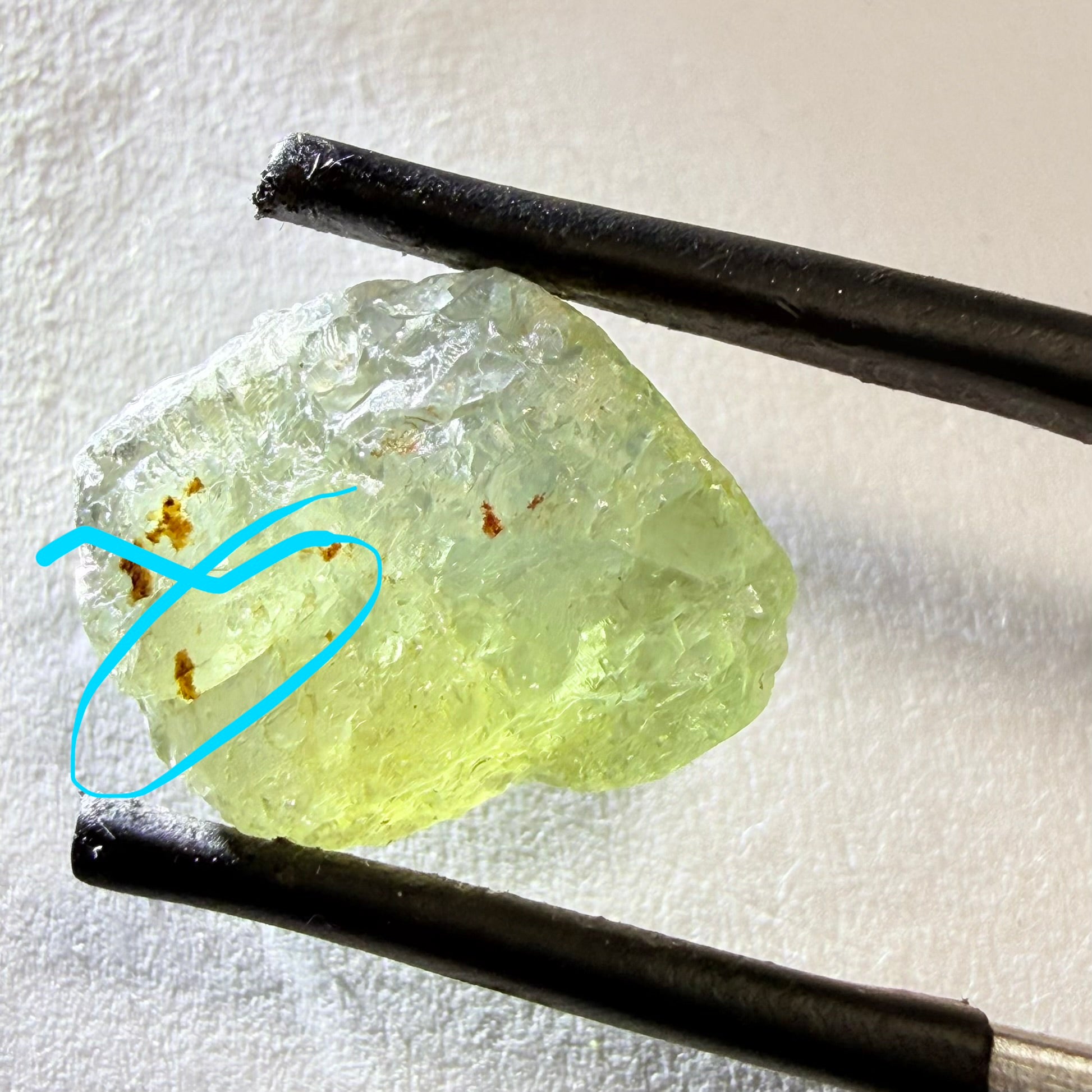 Umba Sapphire, 14.72ct, Umba Valley, Tanzania, Untreated Unheated. Slightly to moderately included,  slight silk, crack going a 1/4 way in. See the backlit pics  I have circled the crack, minor fissures to be removed before faceting