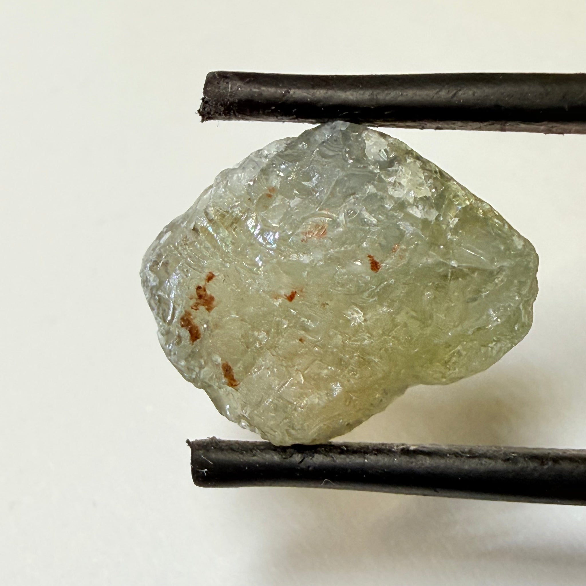 Umba Sapphire, 14.72ct, Umba Valley, Tanzania, Untreated Unheated. Slightly to moderately included,  slight silk, crack going a 1/4 way in. See the backlit pics  I have circled the crack, minor fissures to be removed before faceting