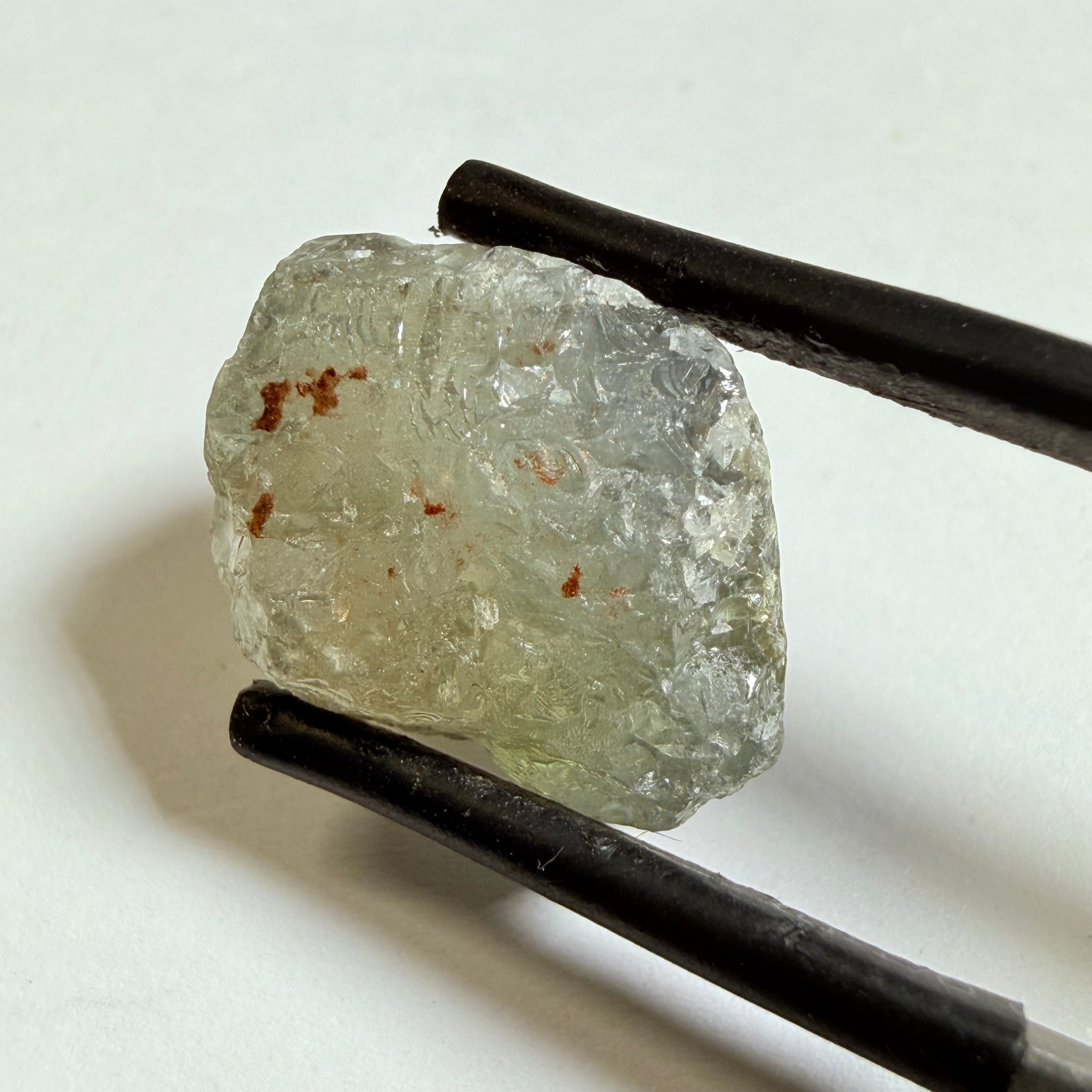 Umba Sapphire, 14.72ct, Umba Valley, Tanzania, Untreated Unheated. Slightly to moderately included,  slight silk, crack going a 1/4 way in. See the backlit pics  I have circled the crack, minor fissures to be removed before faceting