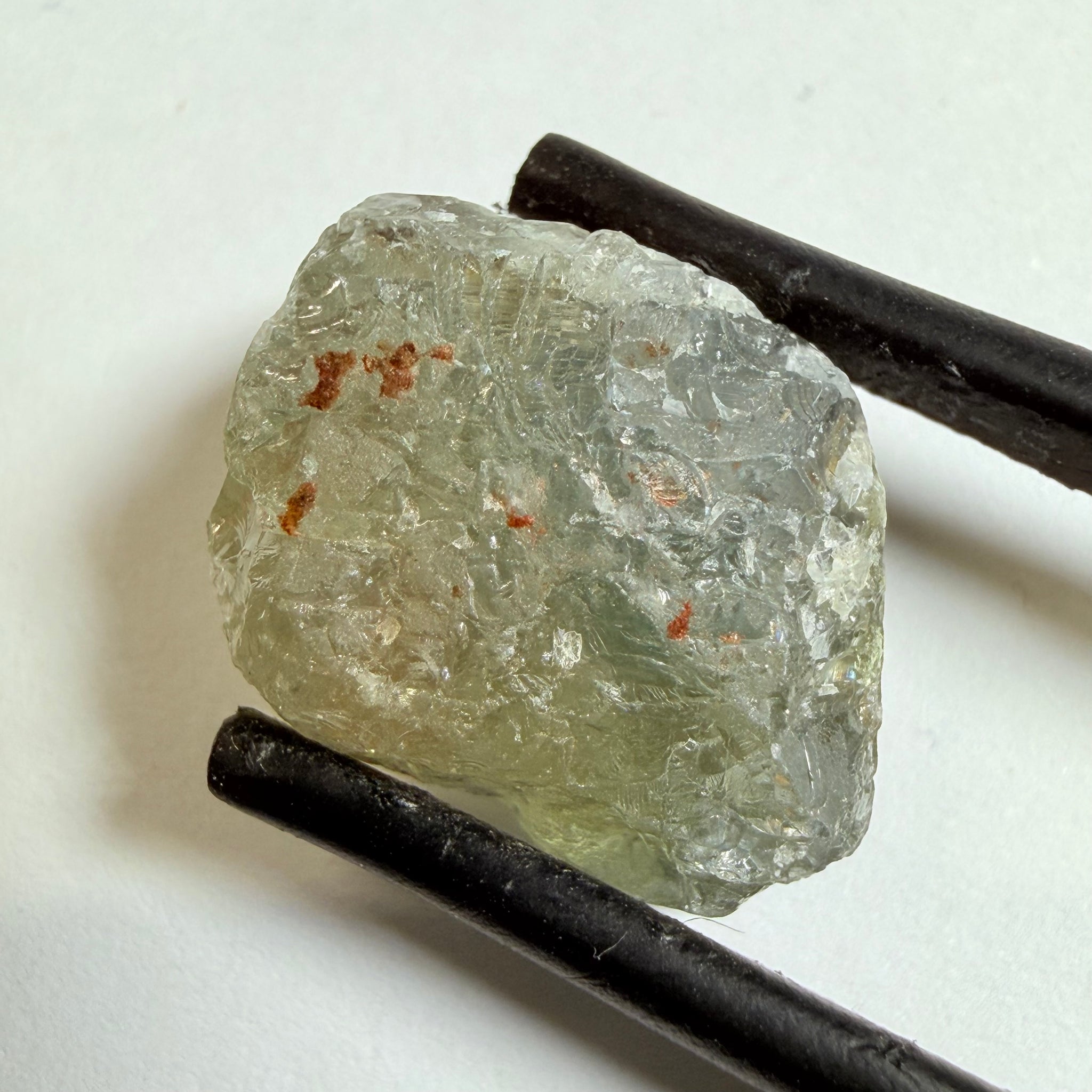 Umba Sapphire, 14.72ct, Umba Valley, Tanzania, Untreated Unheated. Slightly to moderately included,  slight silk, crack going a 1/4 way in. See the backlit pics  I have circled the crack, minor fissures to be removed before faceting