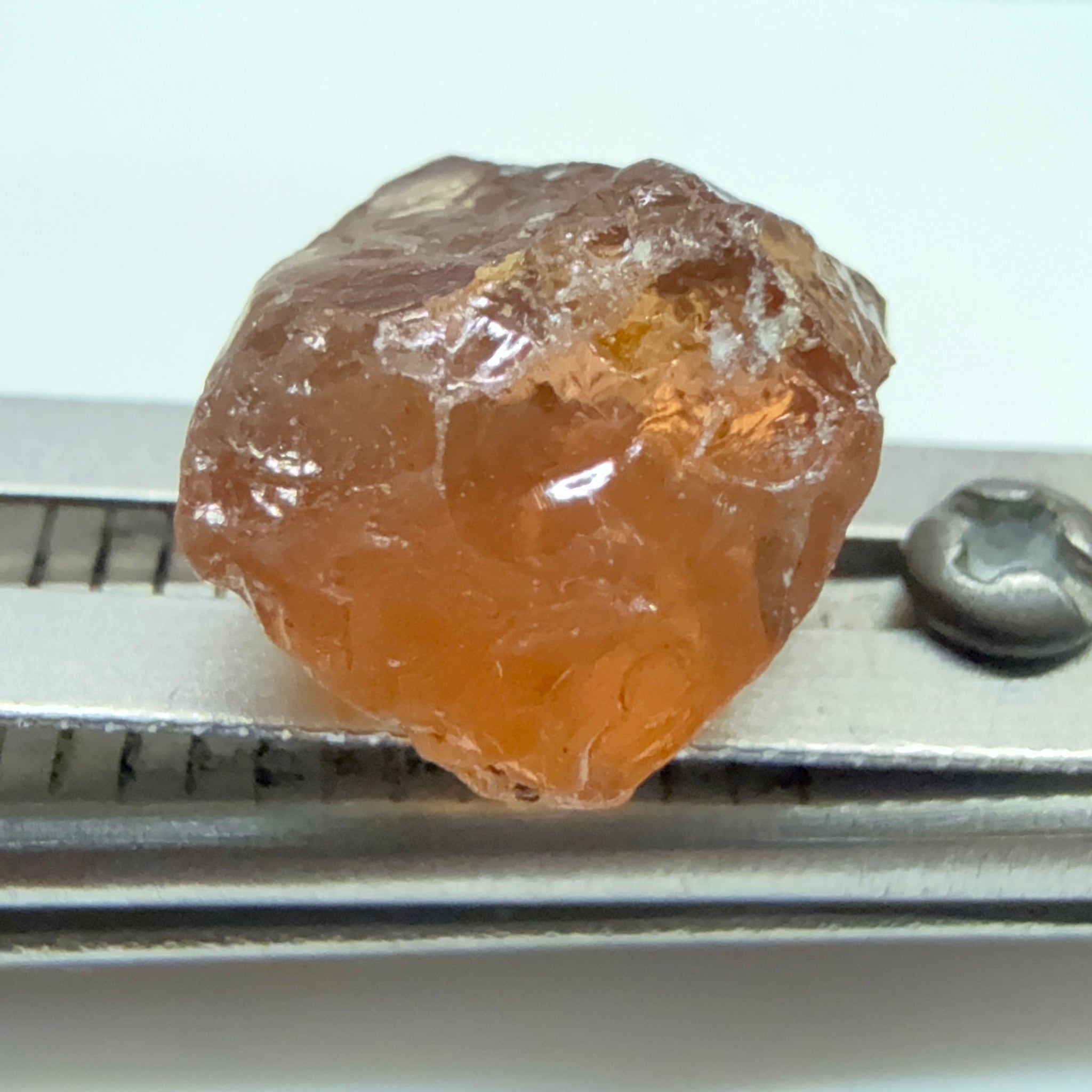 Peach Malaya Garnet, 6.02ct, slight crack 1mm inside from skin, slight gunk on skin on one end needs to be removed on disk, rest slightly silky, Unheated Untreated, Umba Valley Tanzania