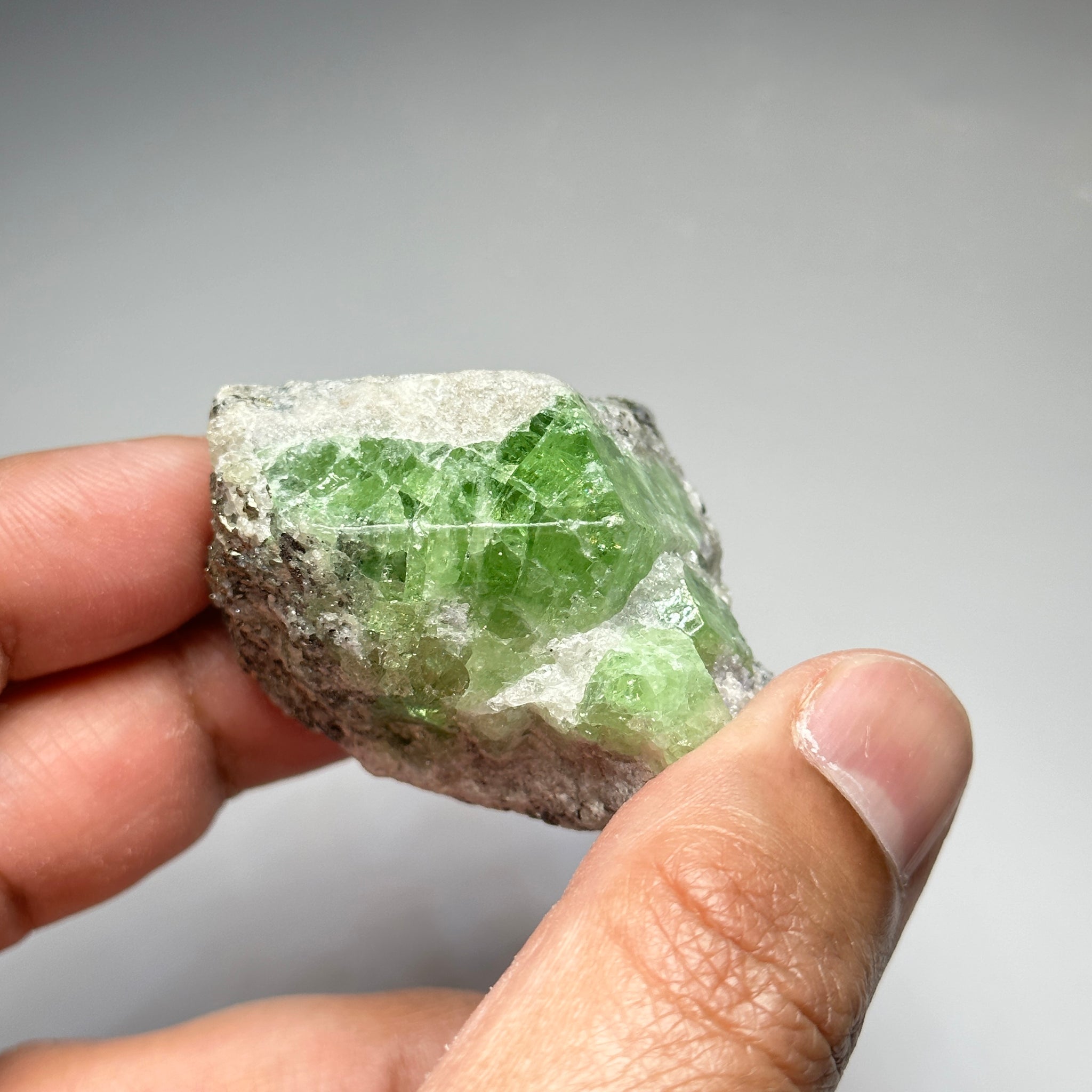 Tsavorite Crystal With Tanzanite And Pyrite on Matrix, 84.30gm / 421.50ct, Merelani, Tanzania. 47 x 36 x 39mm Gem portions and sharp point on crystals