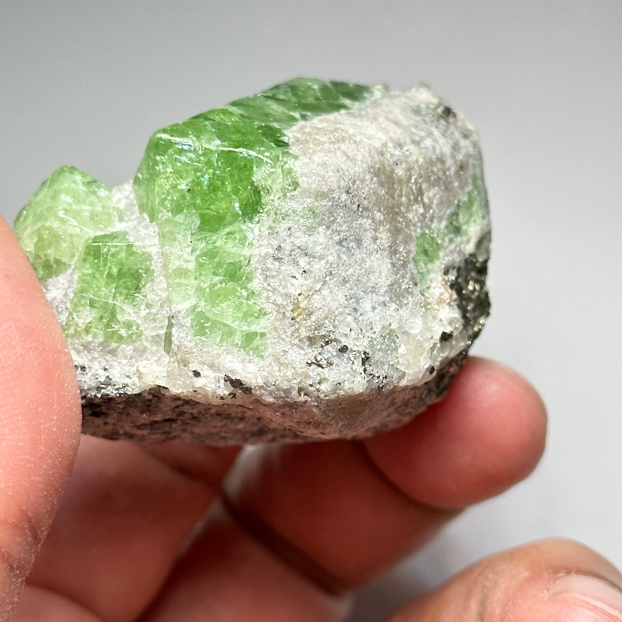 Tsavorite Crystal With Tanzanite And Pyrite on Matrix, 84.30gm / 421.50ct, Merelani, Tanzania. 47 x 36 x 39mm Gem portions and sharp point on crystals