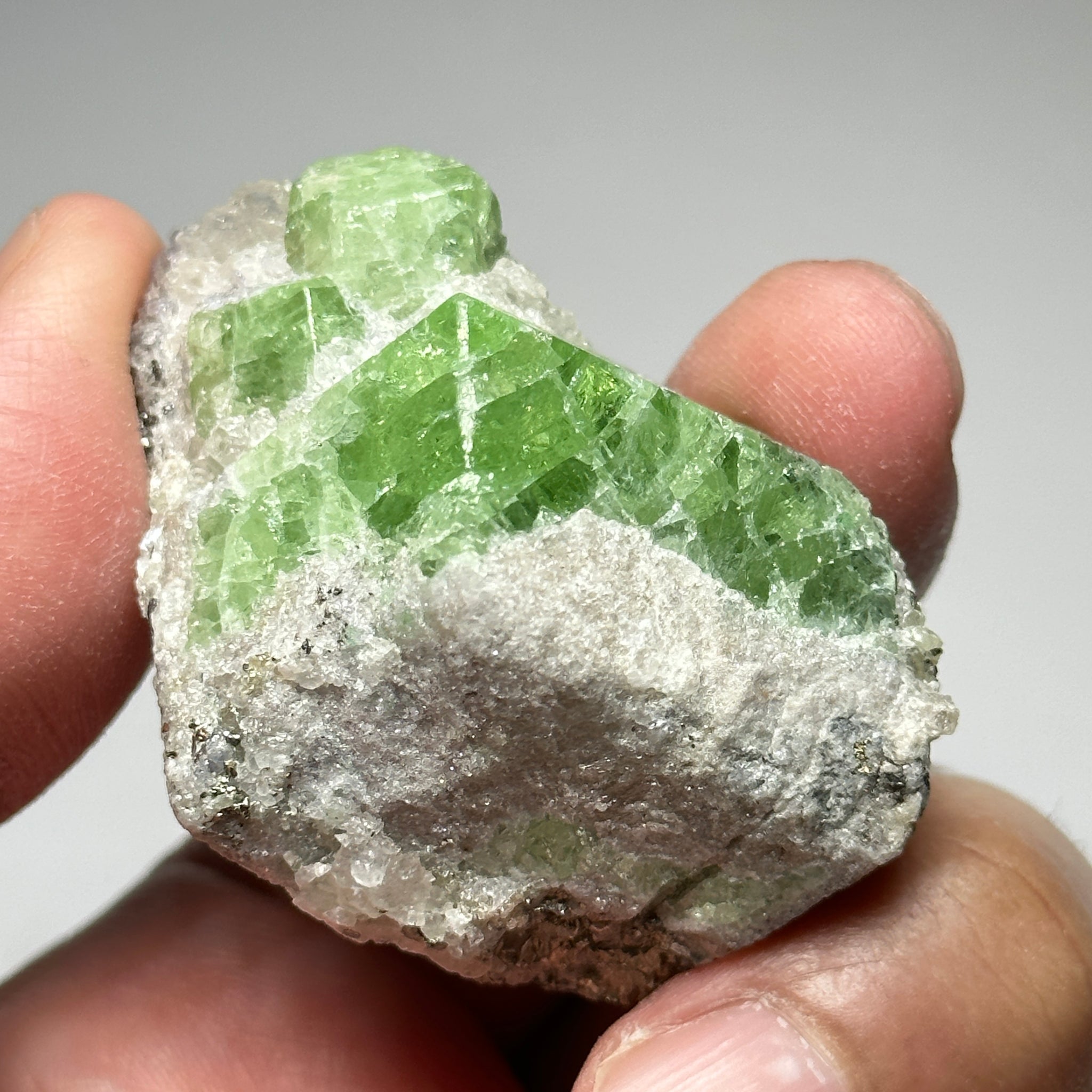 Tsavorite Crystal With Tanzanite And Pyrite on Matrix, 84.30gm / 421.50ct, Merelani, Tanzania. 47 x 36 x 39mm Gem portions and sharp point on crystals