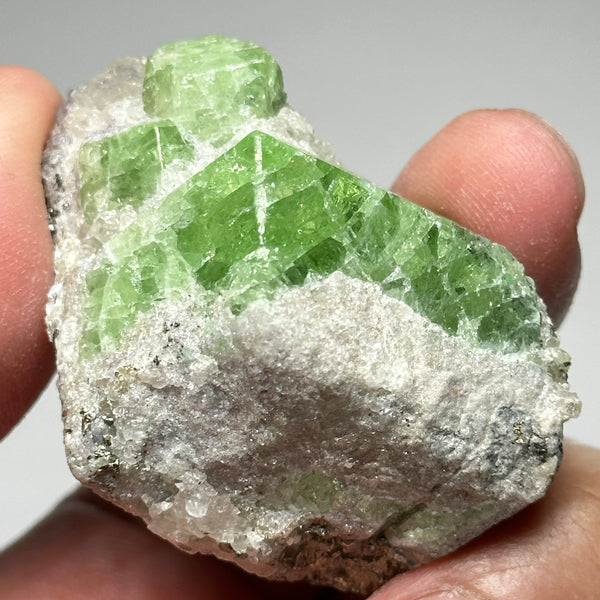 Tsavorite Crystal With Tanzanite And Pyrite on Matrix, 84.30gm / 421.50ct, Merelani, Tanzania. 47 x 36 x 39mm Gem portions and sharp point on crystals
