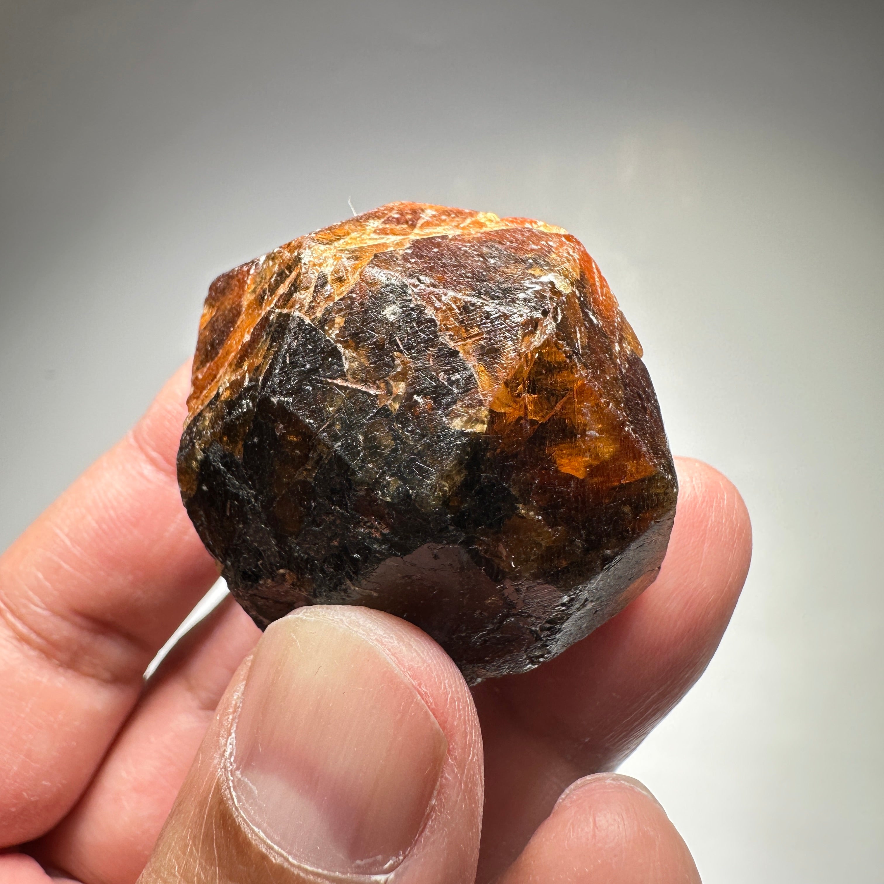 120gm / 600.00cts Large Mandarin Spessartite Garnet 41 X 38 X 38 mm, Untreated Unheated, Tanzania. Bit dark but is full of faceting grade portions see backlit photos, would normally have been broken for its faceting rough