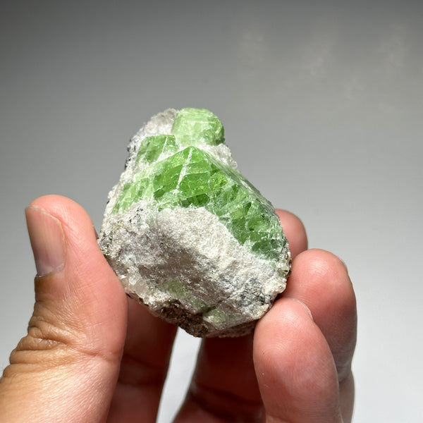 Tsavorite Crystal With Tanzanite And Pyrite on Matrix, 84.30gm / 421.50ct, Merelani, Tanzania. 47 x 36 x 39mm Gem portions and sharp point on crystals