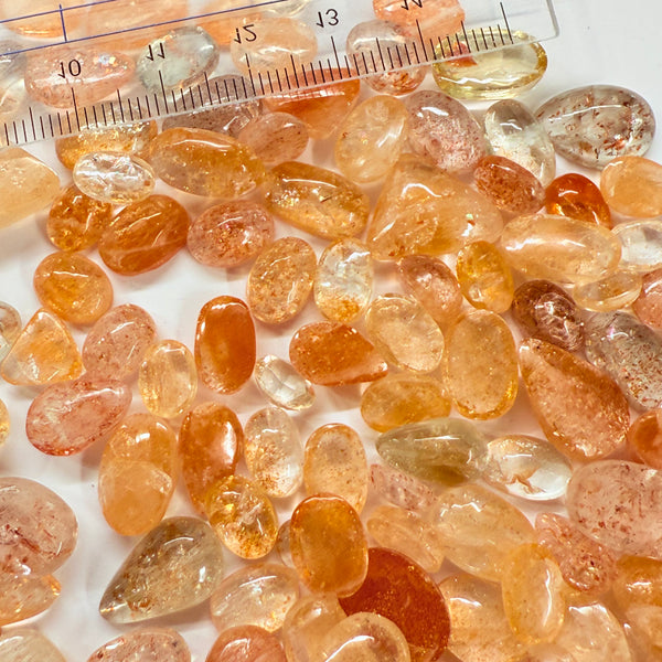 Wholesale Sunstone Cab Lot, flat backed cabs, 228gm / 1140ct, Comminly called Maasai Confetti Sunstone, Tanzania, Untreated Unheated, photos and vids in different lights, see how they look
