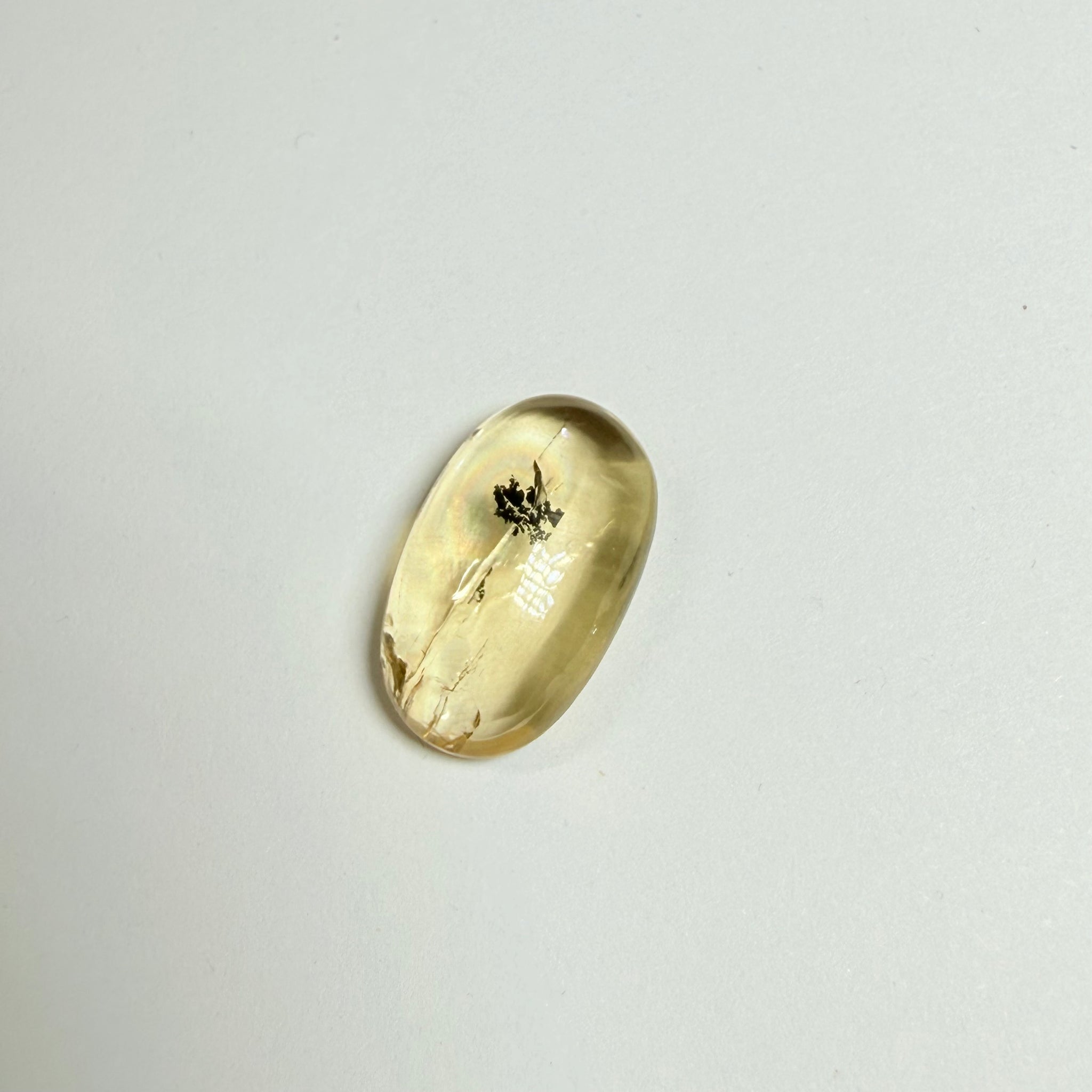 Golden Scapolite Cabochon with a dendrite, and a halo forming around the dendrite from a fracture, 11.53ct, Tanzania, Untreated Unheated