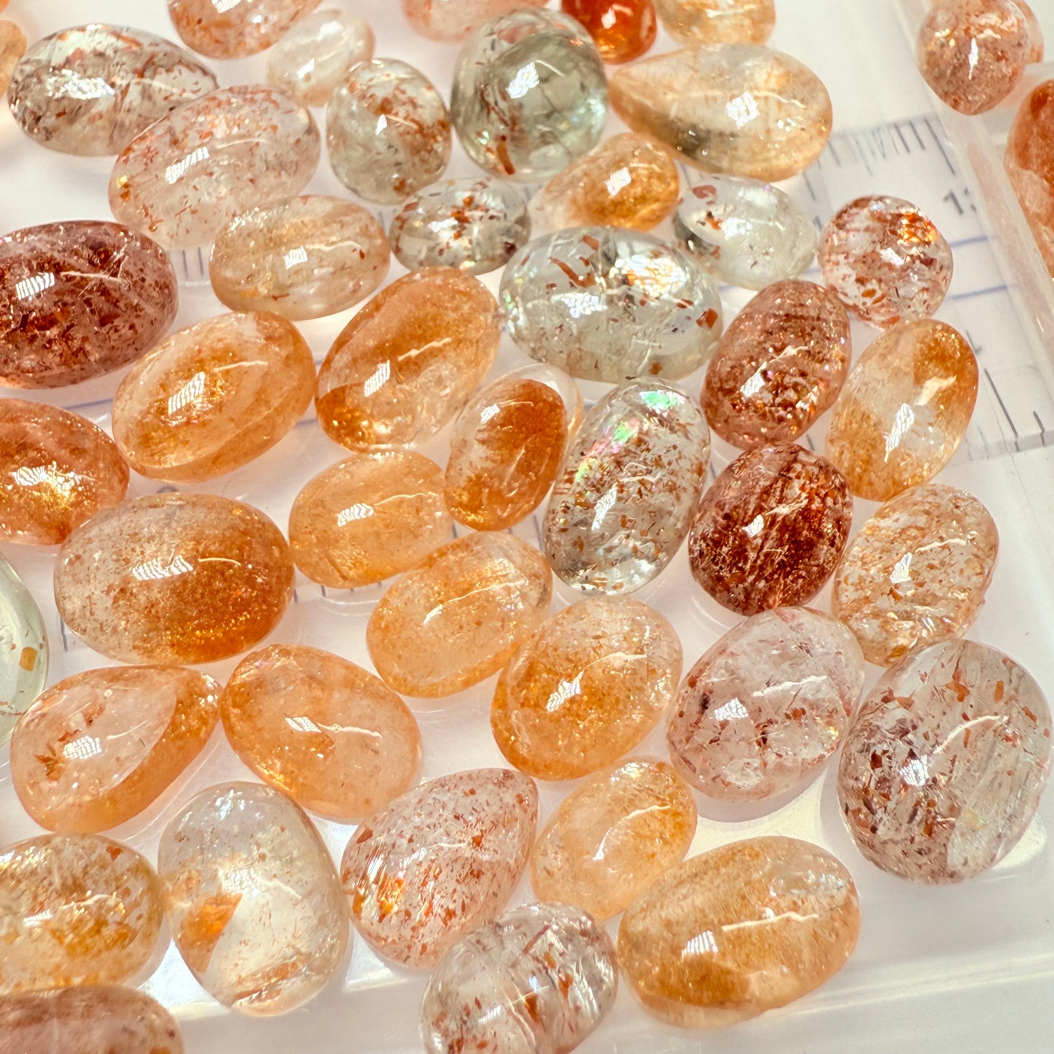 Wholesale Sunstone Cab Lot, flat backed cabs, 228gm / 1140ct, Comminly called Maasai Confetti Sunstone, Tanzania, Untreated Unheated, photos and vids in different lights, see how they look