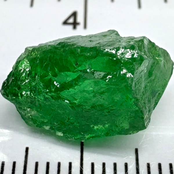 Tsavorite Garnet, 8.64ct, Tanzania, Untreated Unheated. Has a crack at one end, you can see the light reflecting on the left side, see circled pic. Rest has spots and veils, but well saturated colour