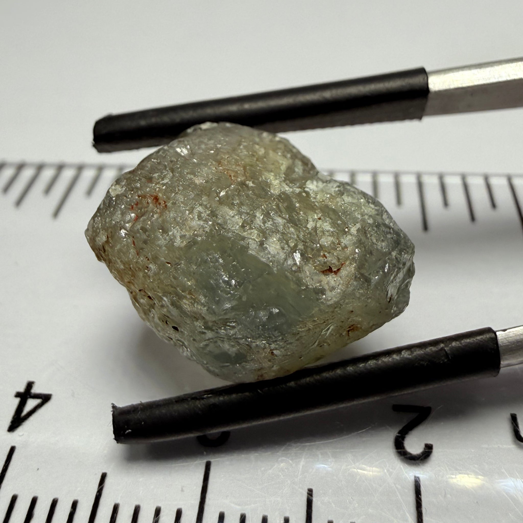 Umba Sapphire, 14.72ct, Umba Valley, Tanzania, Untreated Unheated. Slightly to moderately included,  slight silk, crack going a 1/4 way in. See the backlit pics  I have circled the crack, minor fissures to be removed before faceting