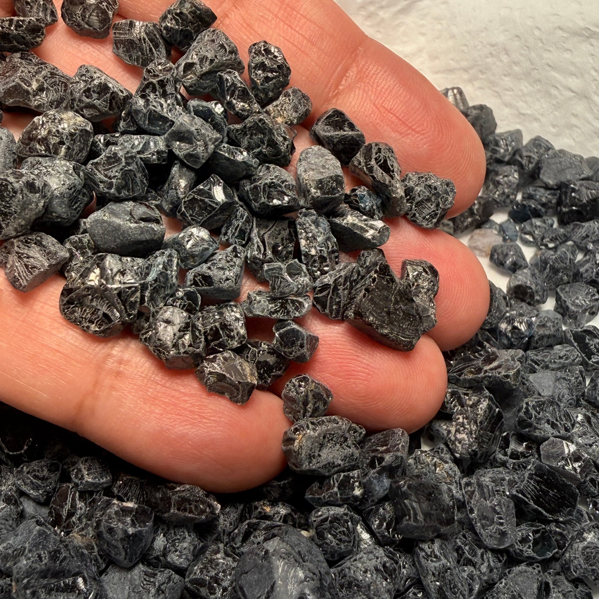 Midnight Blue Spinel Lot, 309.70gm / 1548.50ct, Mozambique, Untreated Unheated. All transparent stones, midnight blue but dark in normal light. See both videos. Almost all are vvs. Not sure if heat will lighten it. 3ct-11ct
