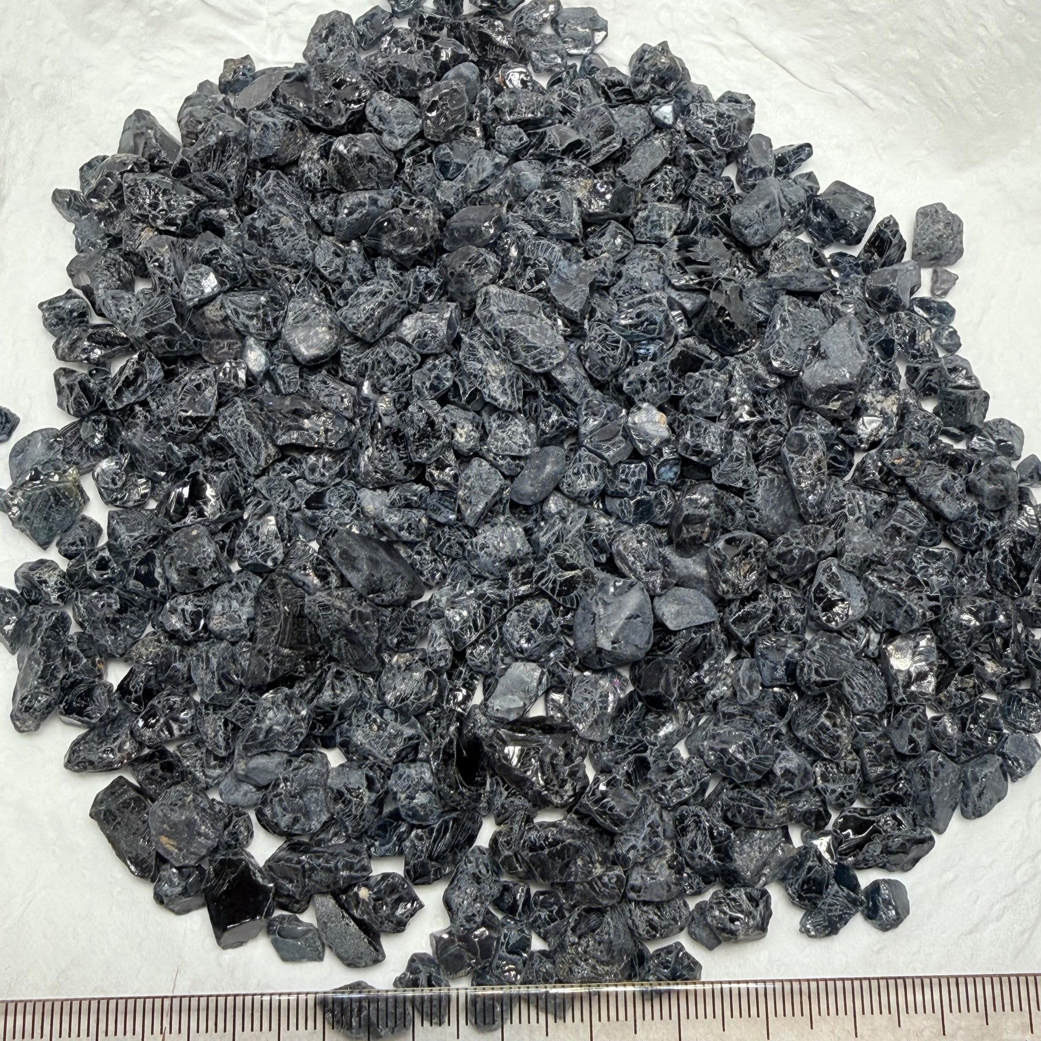 Midnight Blue Spinel Lot, 309.70gm / 1548.50ct, Mozambique, Untreated Unheated. All transparent stones, midnight blue but dark in normal light. See both videos. Almost all are vvs. Not sure if heat will lighten it. 3ct-11ct