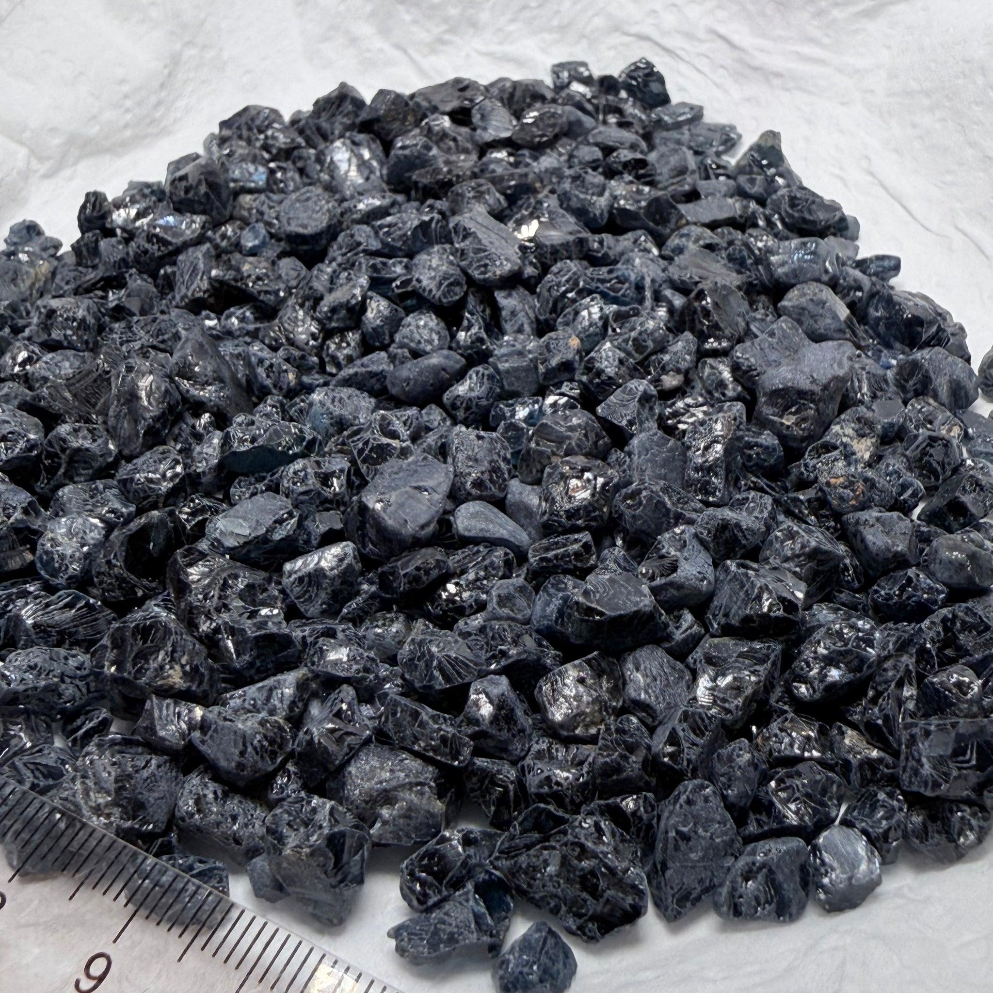 Midnight Blue Spinel Lot, 309.70gm / 1548.50ct, Mozambique, Untreated Unheated. All transparent stones, midnight blue but dark in normal light. See both videos. Almost all are vvs. Not sure if heat will lighten it. 3ct-11ct