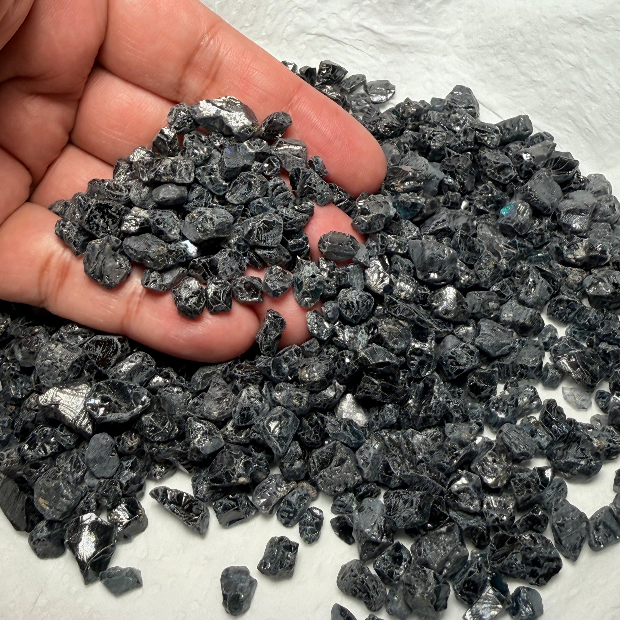 Midnight Blue Spinel Lot, 309.70gm / 1548.50ct, Mozambique, Untreated Unheated. All transparent stones, midnight blue but dark in normal light. See both videos. Almost all are vvs. Not sure if heat will lighten it. 3ct-11ct