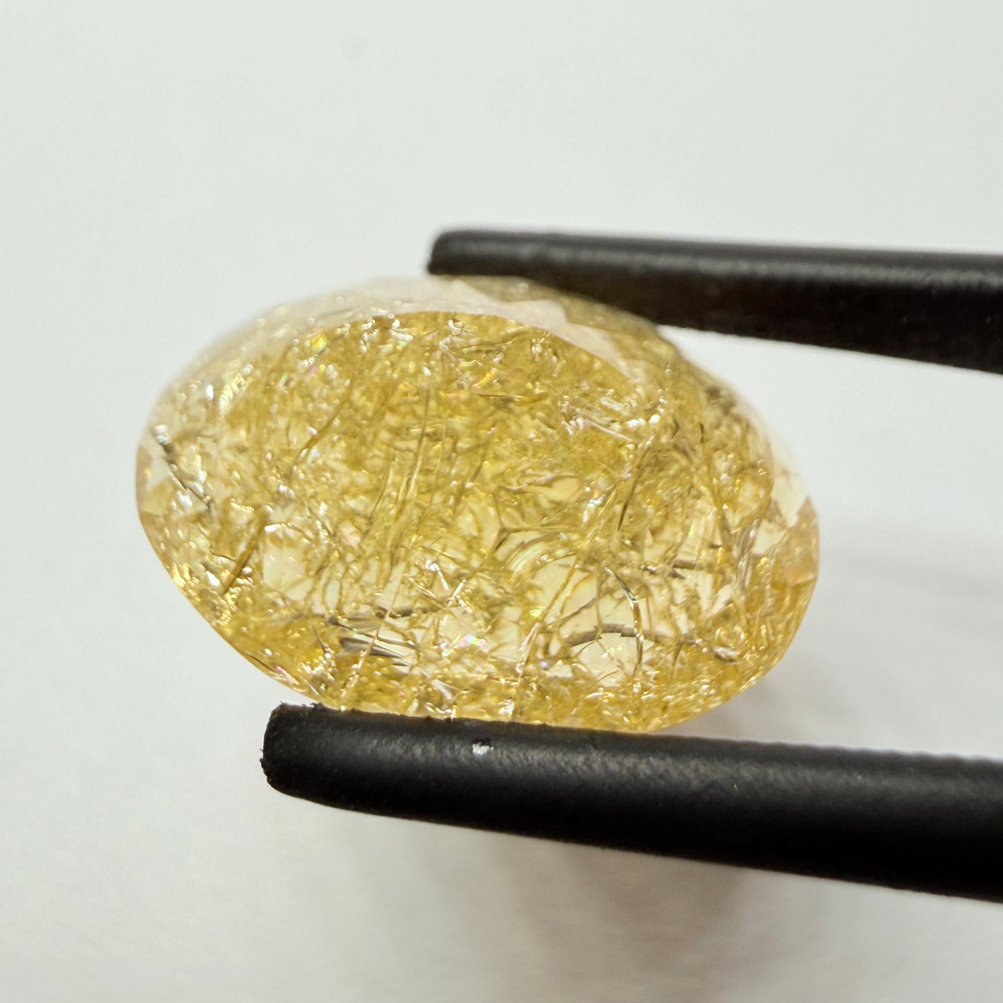 Ethiopian Opal that we cut 17 years ago and fractured internally, seems stable and none of the facets have broken, we thought it was quite pretty, from the initial Ethiopian Opal deposit, 6.87ct, Ethiopia, Untreated Unheated