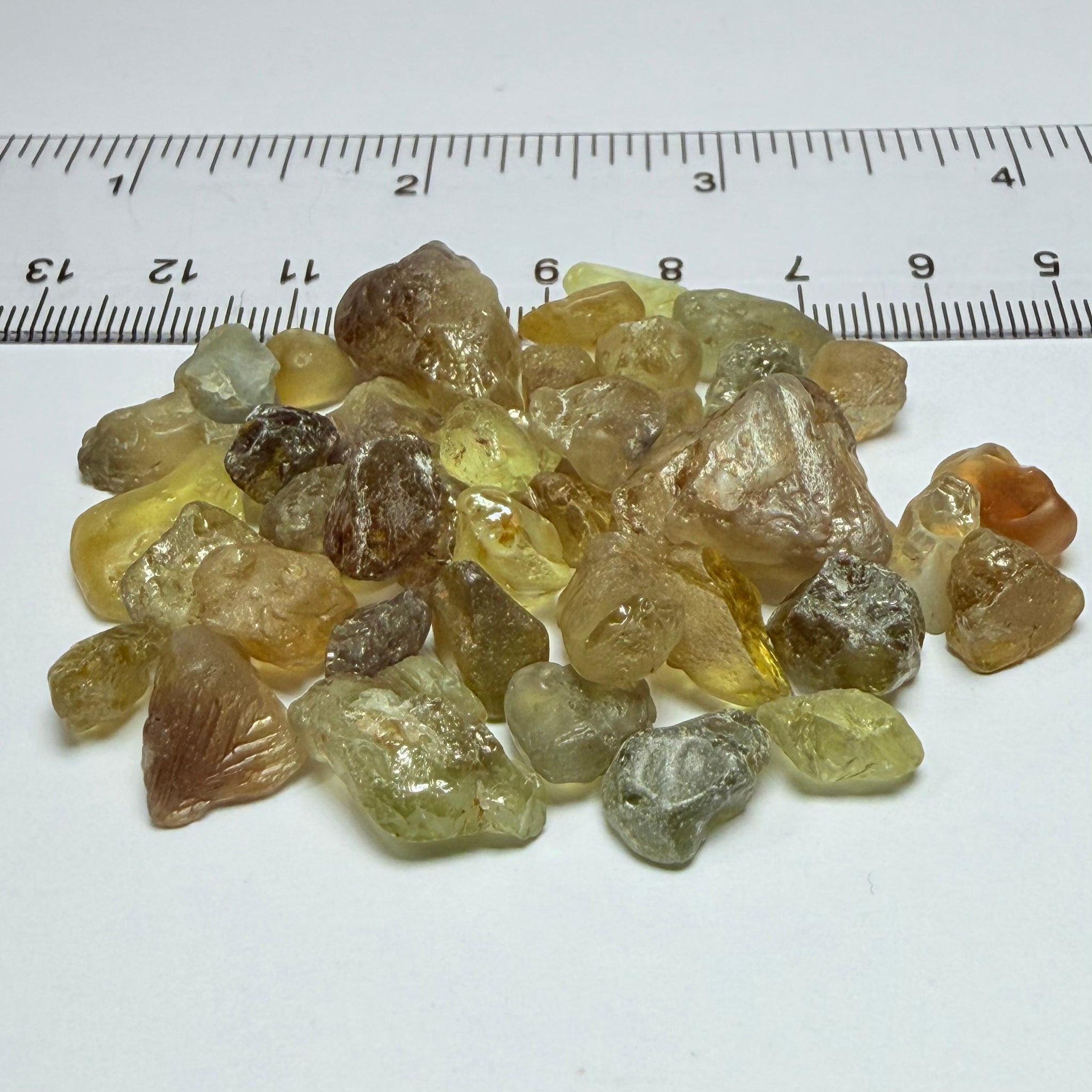 Chrysoberyl lot, 190.09ct, Tunduru, Tanzania, Untreated Unheated. A mix between faceting grade and cabbing grade rough, they change colour but only very very slightly, see video showing the different lights