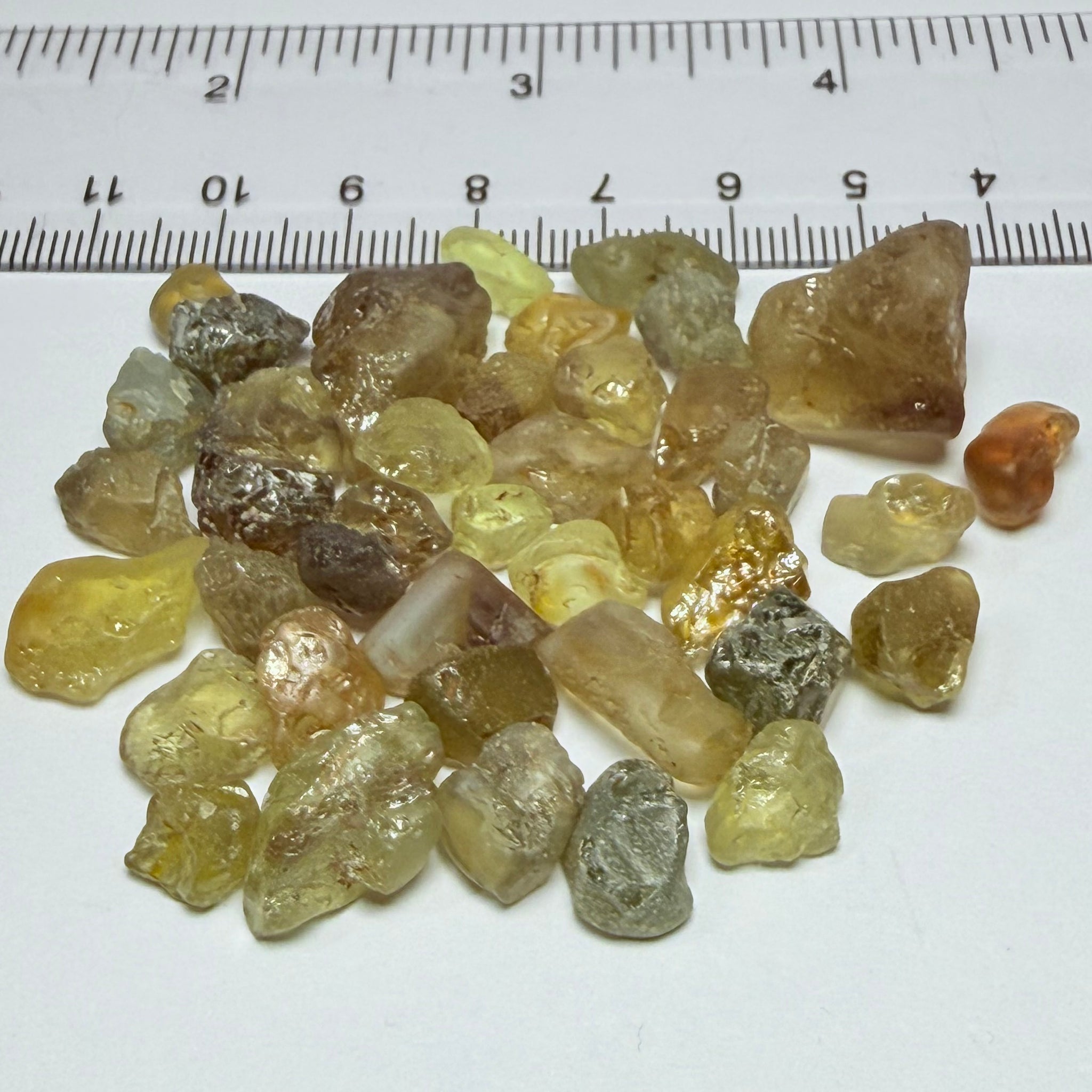 Chrysoberyl lot, 190.09ct, Tunduru, Tanzania, Untreated Unheated. A mix between faceting grade and cabbing grade rough, they change colour but only very very slightly, see video showing the different lights