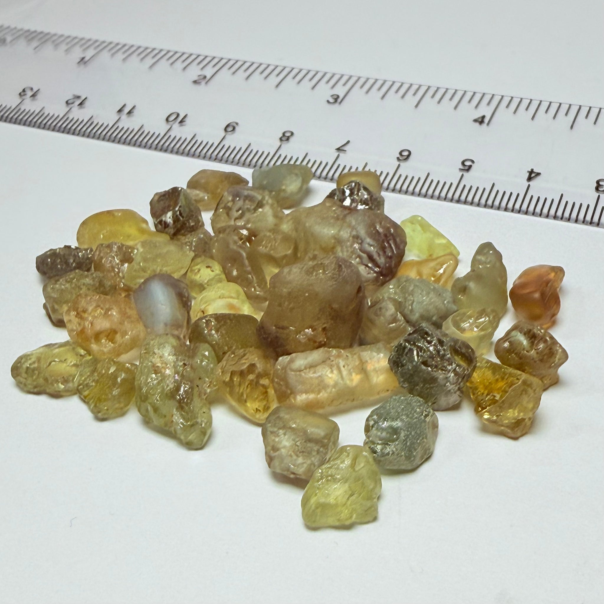 Chrysoberyl lot, 190.09ct, Tunduru, Tanzania, Untreated Unheated. A mix between faceting grade and cabbing grade rough, they change colour but only very very slightly, see video showing the different lights