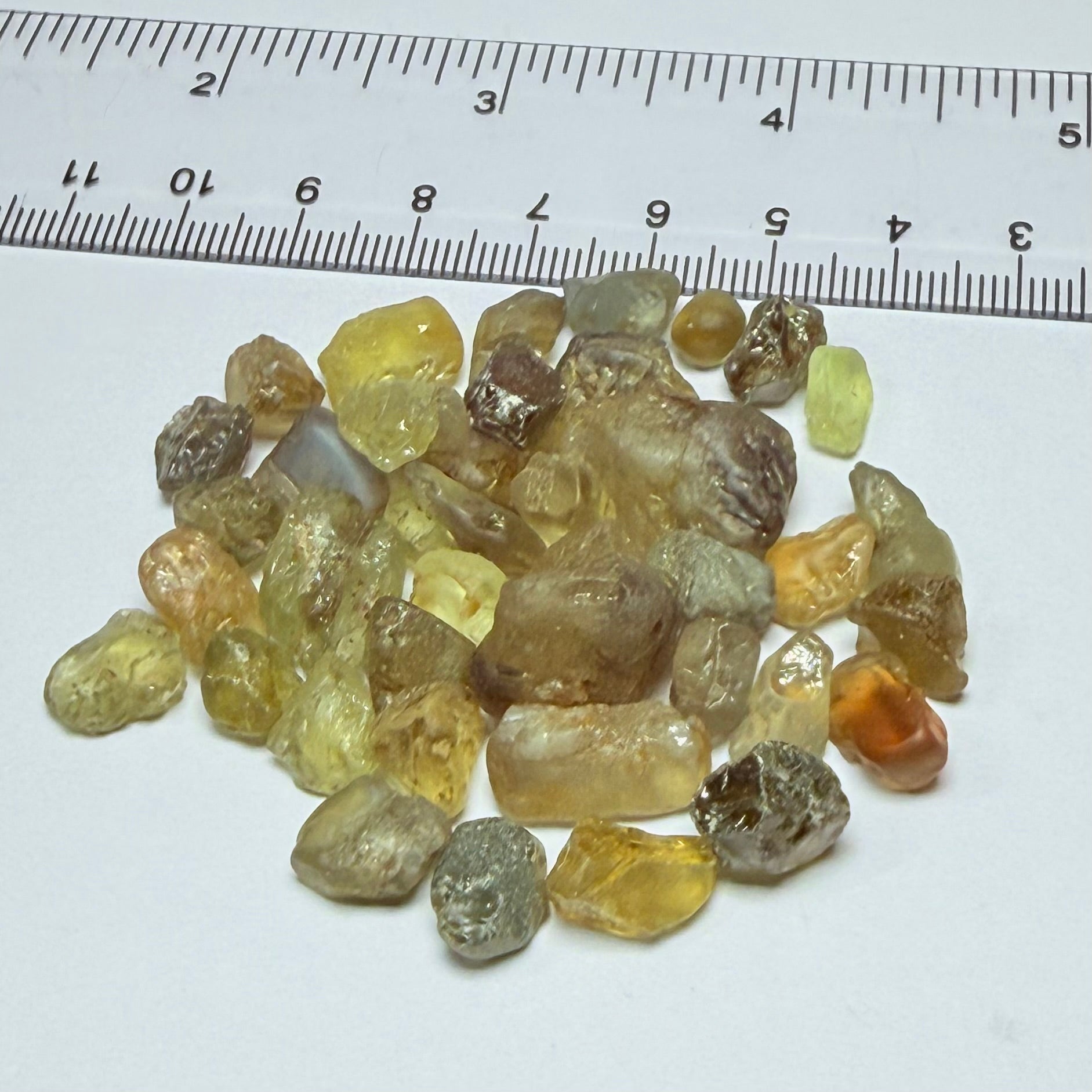Chrysoberyl lot, 190.09ct, Tunduru, Tanzania, Untreated Unheated. A mix between faceting grade and cabbing grade rough, they change colour but only very very slightly, see video showing the different lights