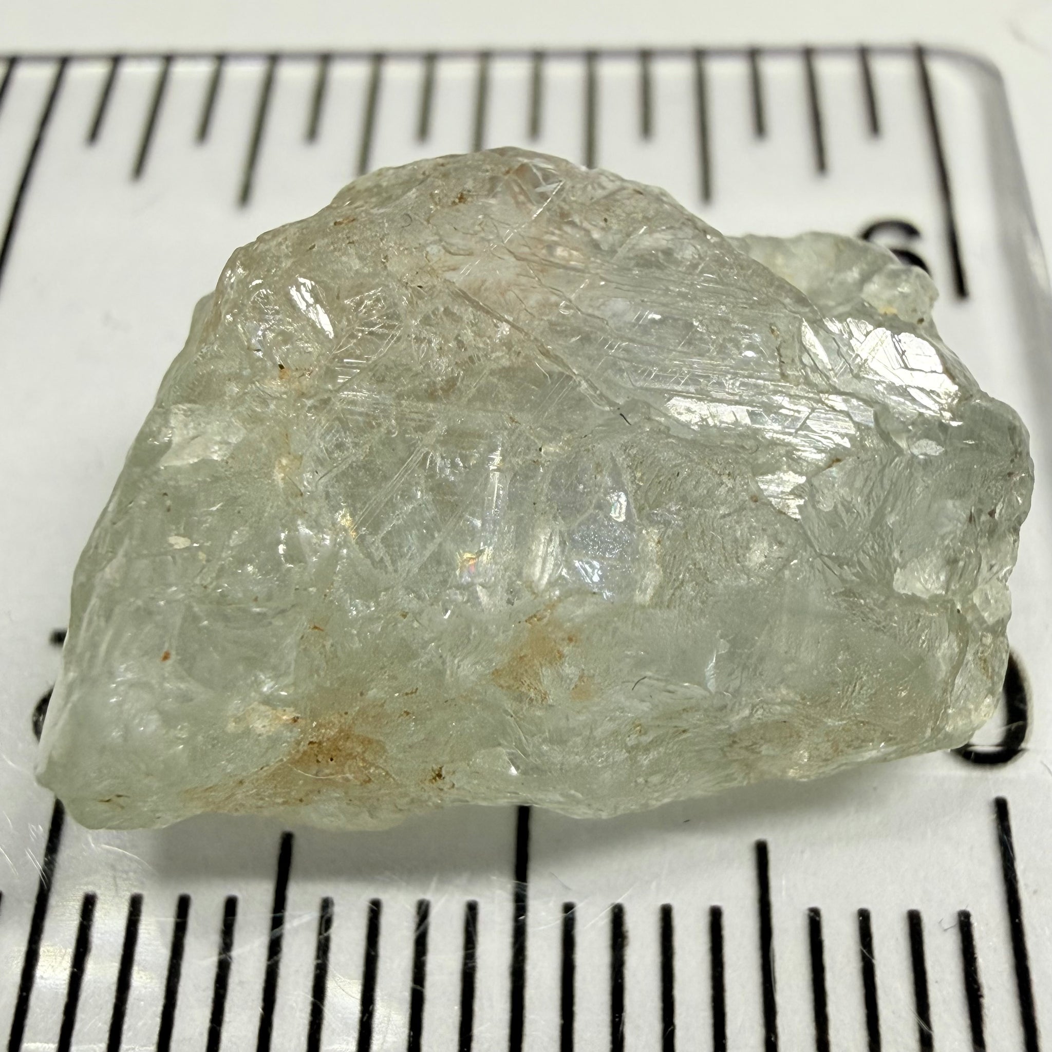 Umba Sapphire, 21.93ct, Umba, Tanzania, Untreated Unheated, flattish shape, moderate to heavy inclusions on the outside with a transparent needled, slightly included center, see the backlit photos