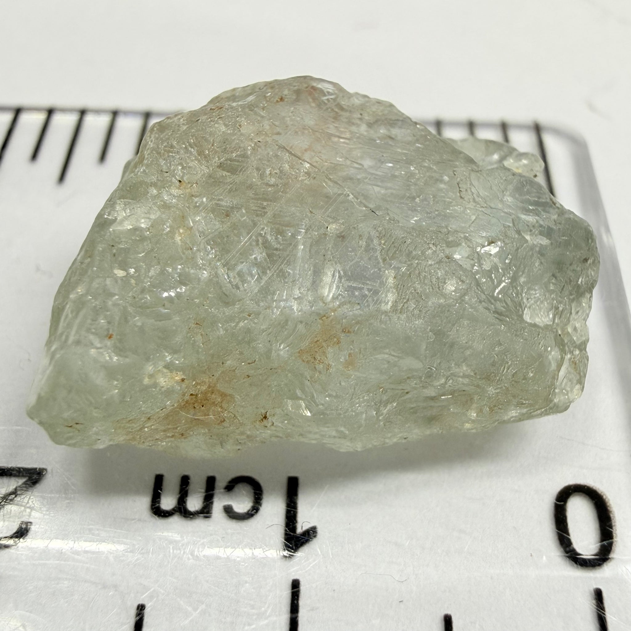Umba Sapphire, 21.93ct, Umba, Tanzania, Untreated Unheated, flattish shape, moderate to heavy inclusions on the outside with a transparent needled, slightly included center, see the backlit photos