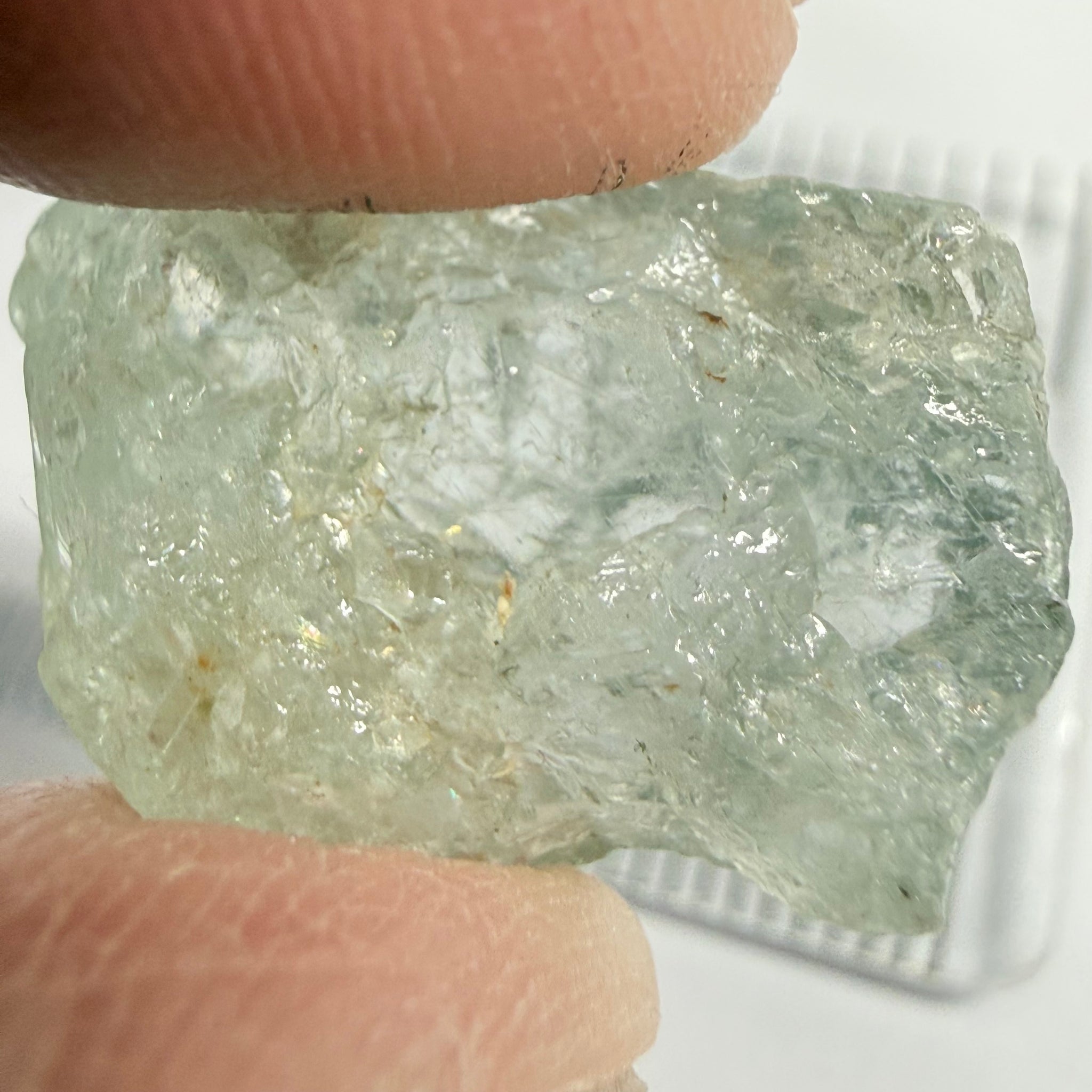 Umba Sapphire, 21.93ct, Umba, Tanzania, Untreated Unheated, flattish shape, moderate to heavy inclusions on the outside with a transparent needled, slightly included center, see the backlit photos