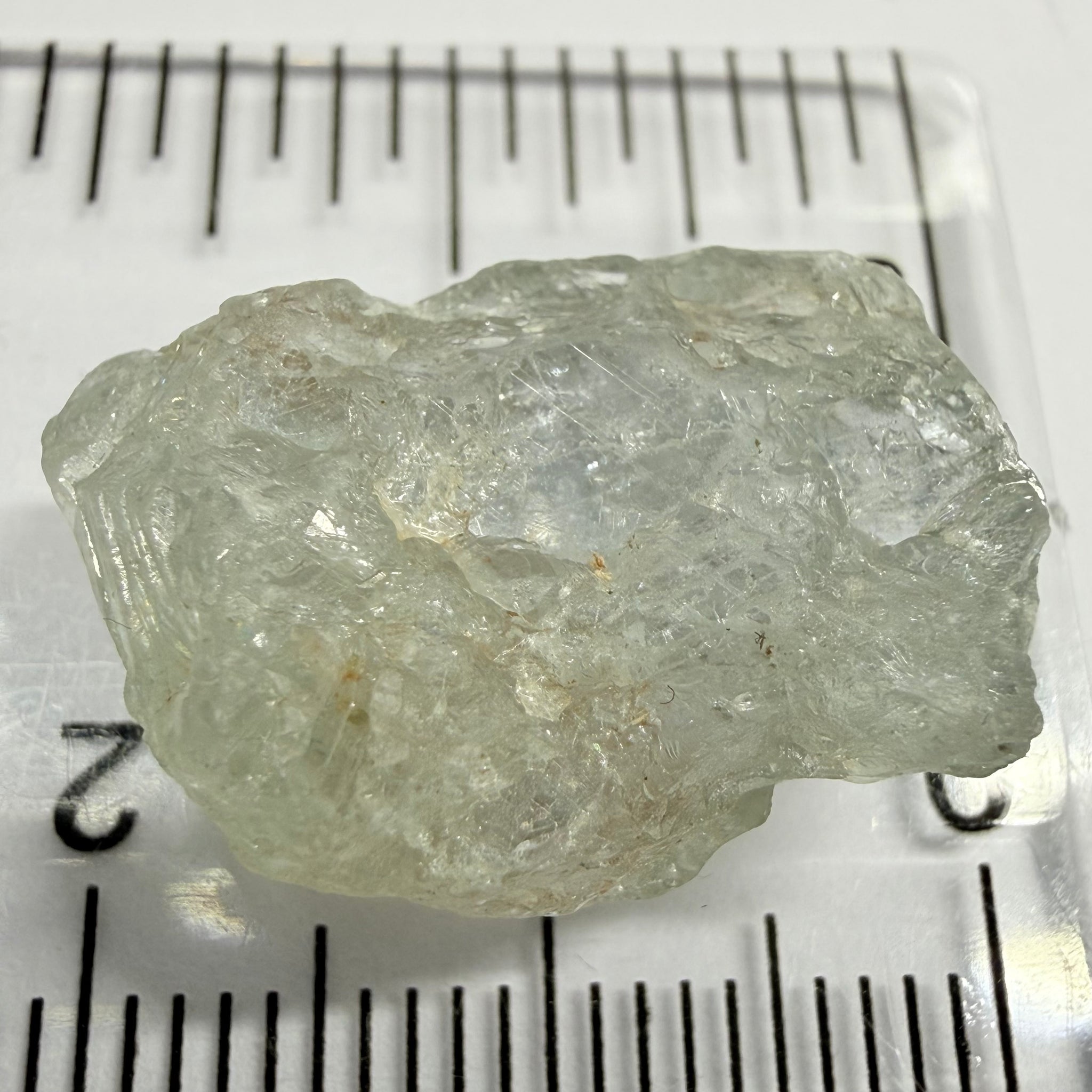 Umba Sapphire, 21.93ct, Umba, Tanzania, Untreated Unheated, flattish shape, moderate to heavy inclusions on the outside with a transparent needled, slightly included center, see the backlit photos
