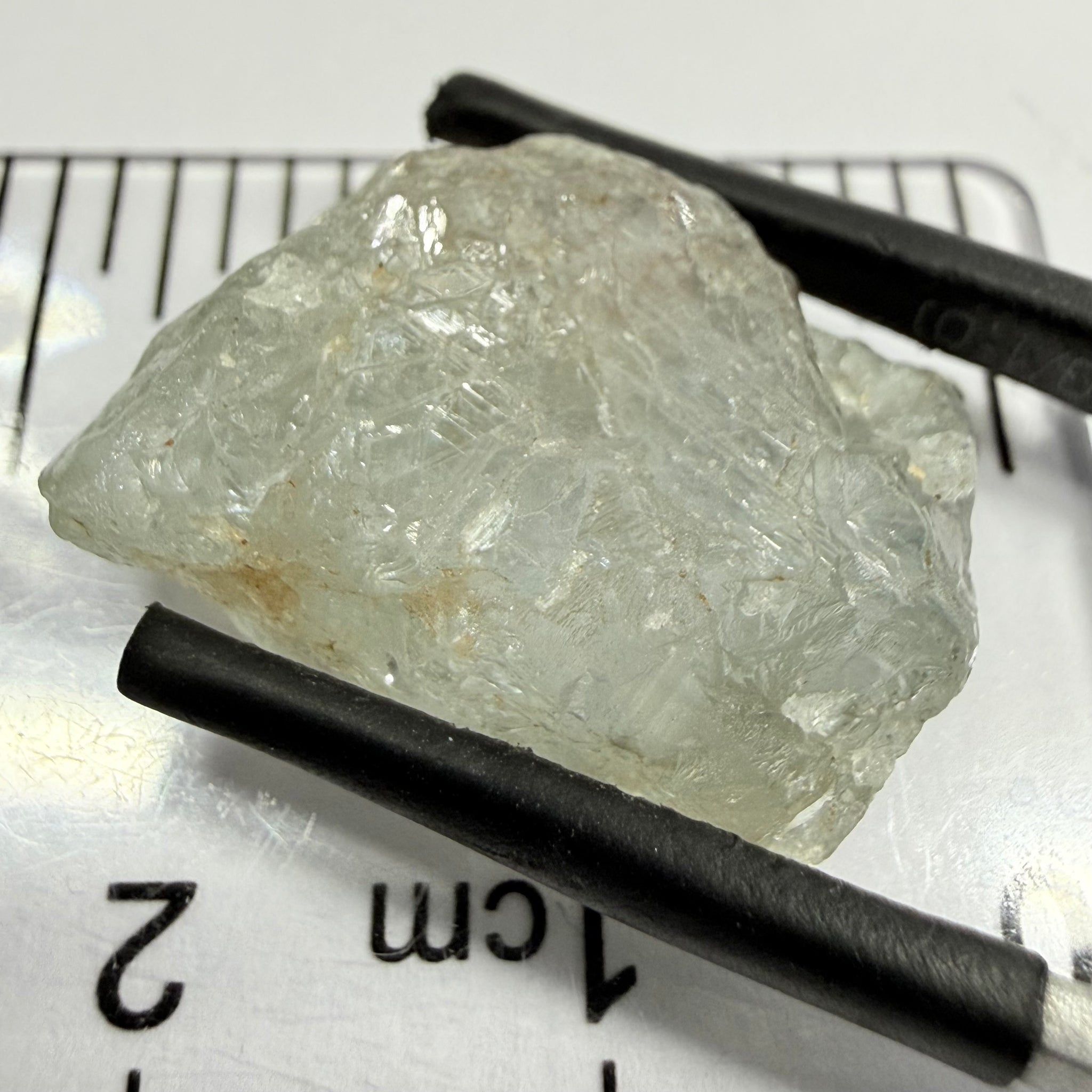 Umba Sapphire, 21.93ct, Umba, Tanzania, Untreated Unheated, flattish shape, moderate to heavy inclusions on the outside with a transparent needled, slightly included center, see the backlit photos