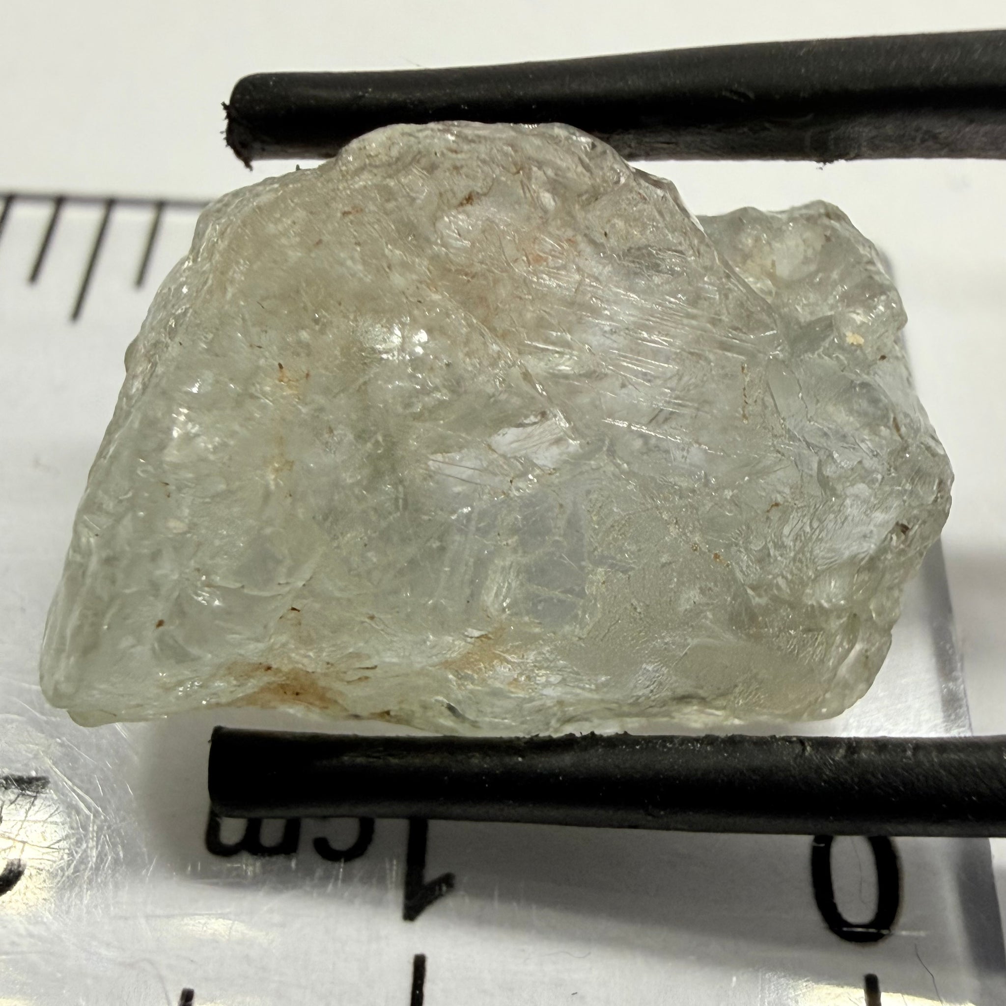 Umba Sapphire, 21.93ct, Umba, Tanzania, Untreated Unheated, flattish shape, moderate to heavy inclusions on the outside with a transparent needled, slightly included center, see the backlit photos