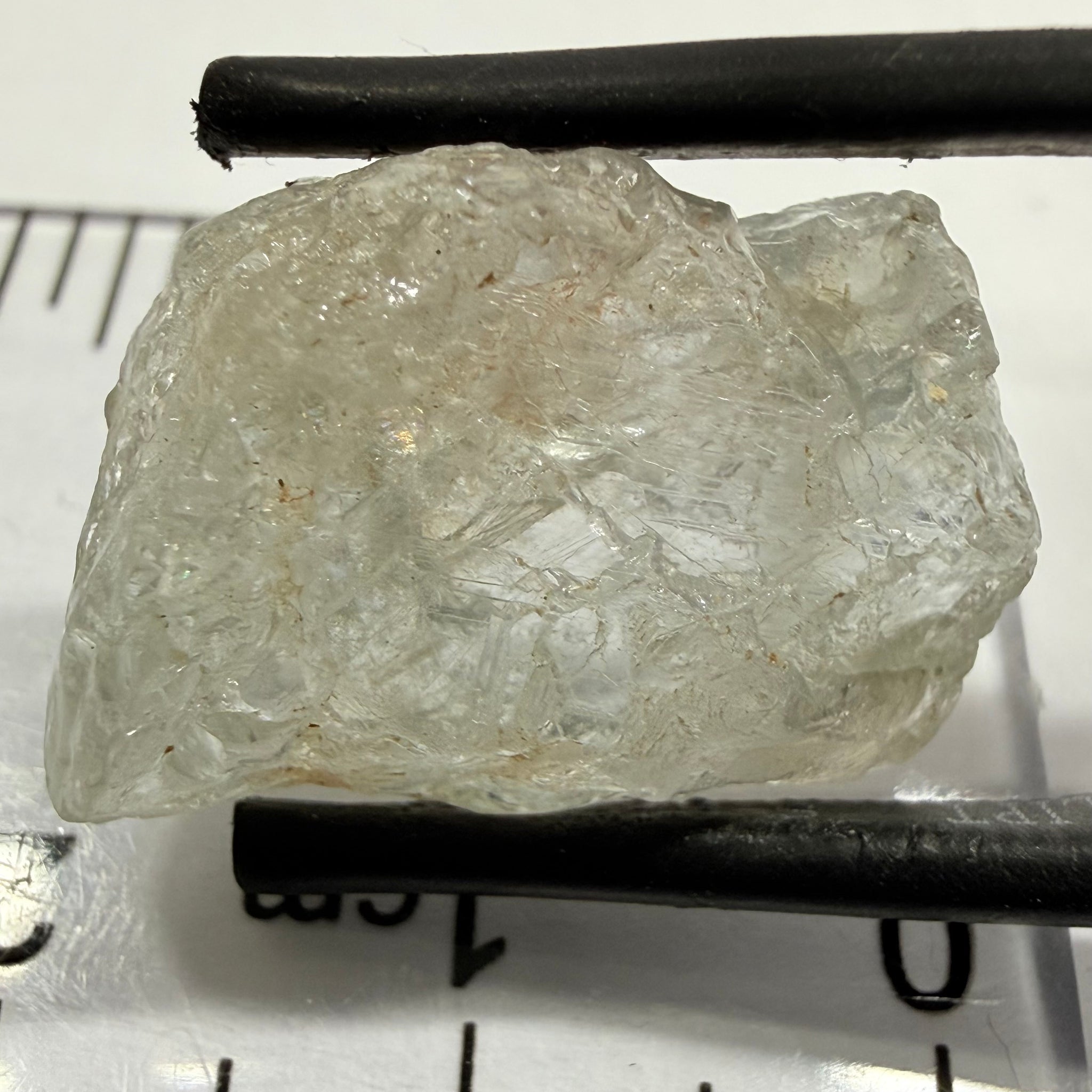 Umba Sapphire, 21.93ct, Umba, Tanzania, Untreated Unheated, flattish shape, moderate to heavy inclusions on the outside with a transparent needled, slightly included center, see the backlit photos