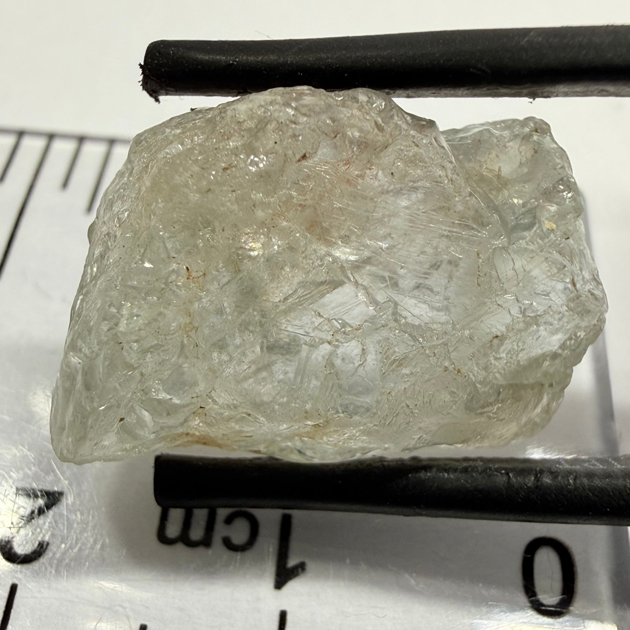 Umba Sapphire, 21.93ct, Umba, Tanzania, Untreated Unheated, flattish shape, moderate to heavy inclusions on the outside with a transparent needled, slightly included center, see the backlit photos