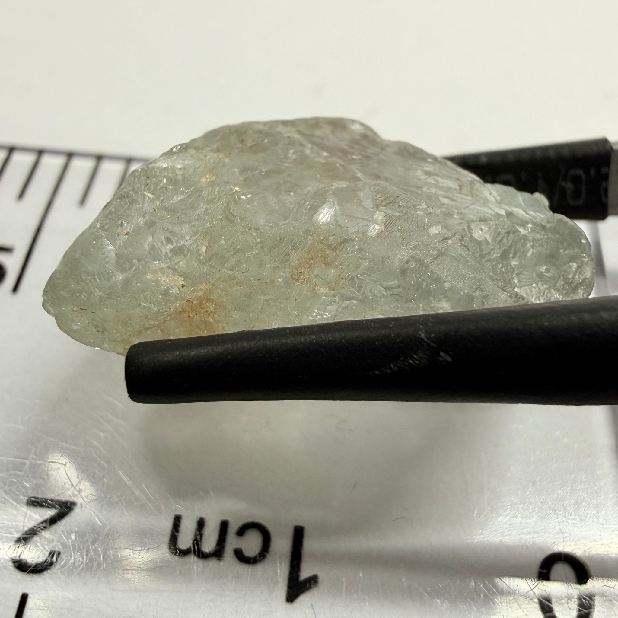 Umba Sapphire, 21.93ct, Umba, Tanzania, Untreated Unheated, flattish shape, moderate to heavy inclusions on the outside with a transparent needled, slightly included center, see the backlit photos