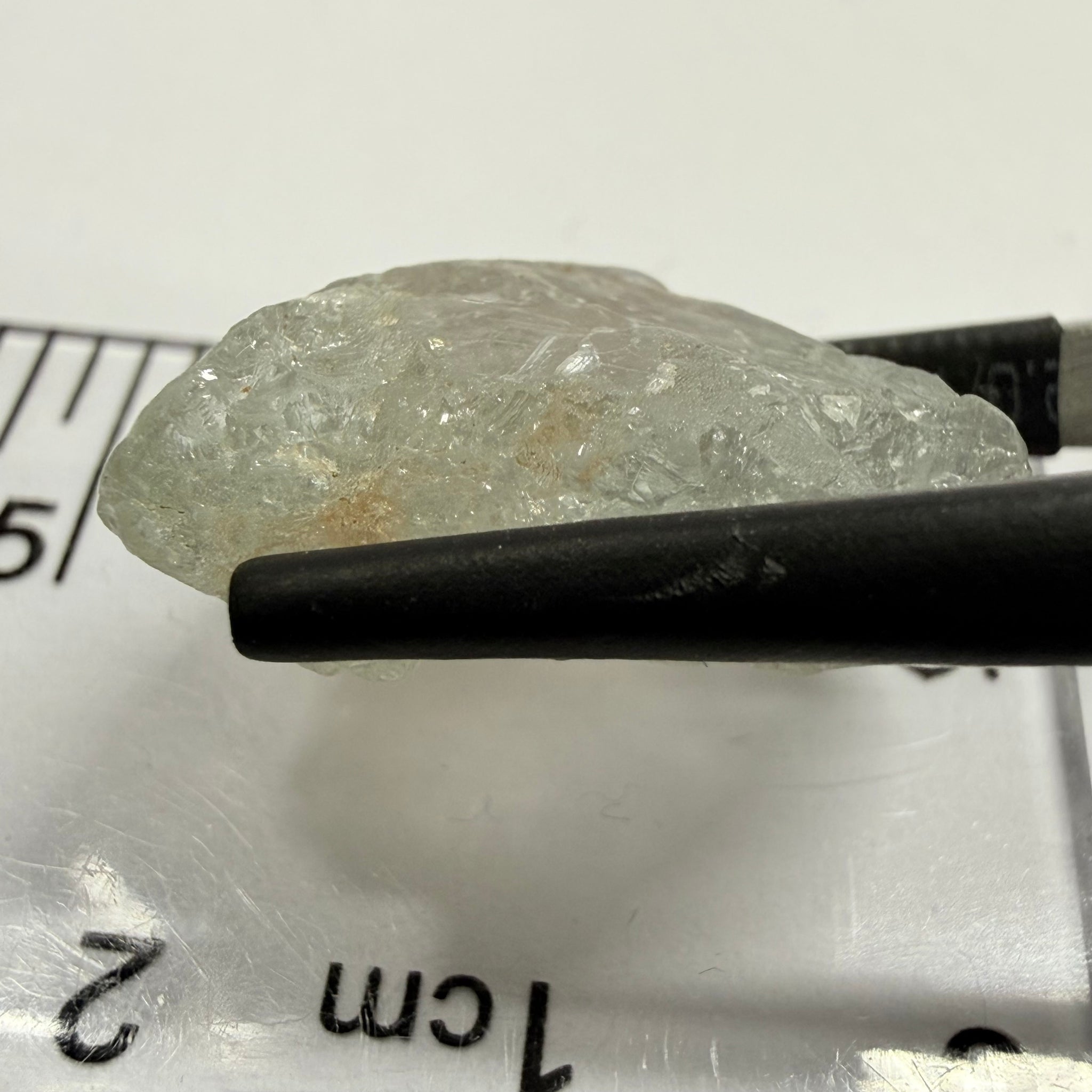 Umba Sapphire, 21.93ct, Umba, Tanzania, Untreated Unheated, flattish shape, moderate to heavy inclusions on the outside with a transparent needled, slightly included center, see the backlit photos