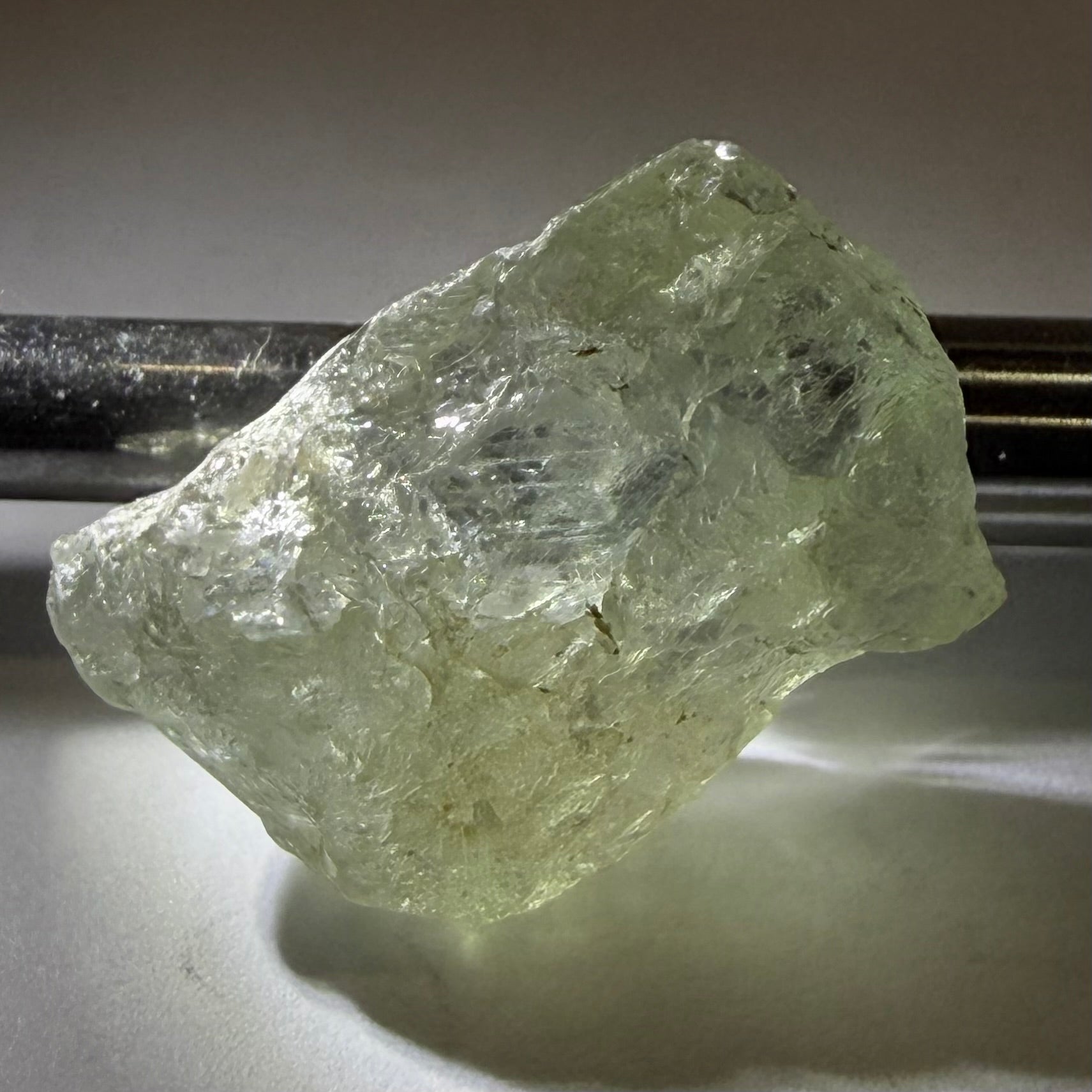 Umba Sapphire, 21.93ct, Umba, Tanzania, Untreated Unheated, flattish shape, moderate to heavy inclusions on the outside with a transparent needled, slightly included center, see the backlit photos