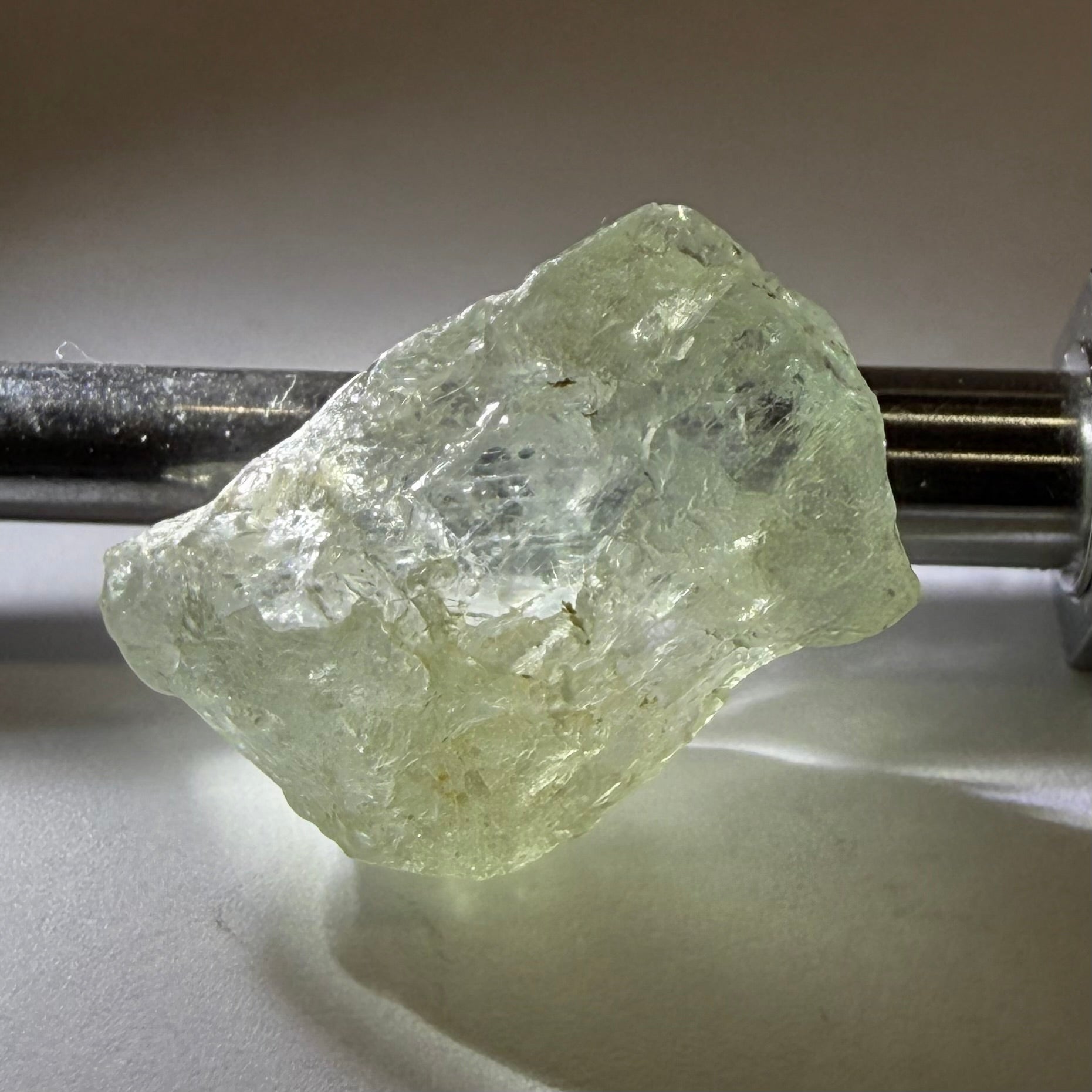 Umba Sapphire, 21.93ct, Umba, Tanzania, Untreated Unheated, flattish shape, moderate to heavy inclusions on the outside with a transparent needled, slightly included center, see the backlit photos