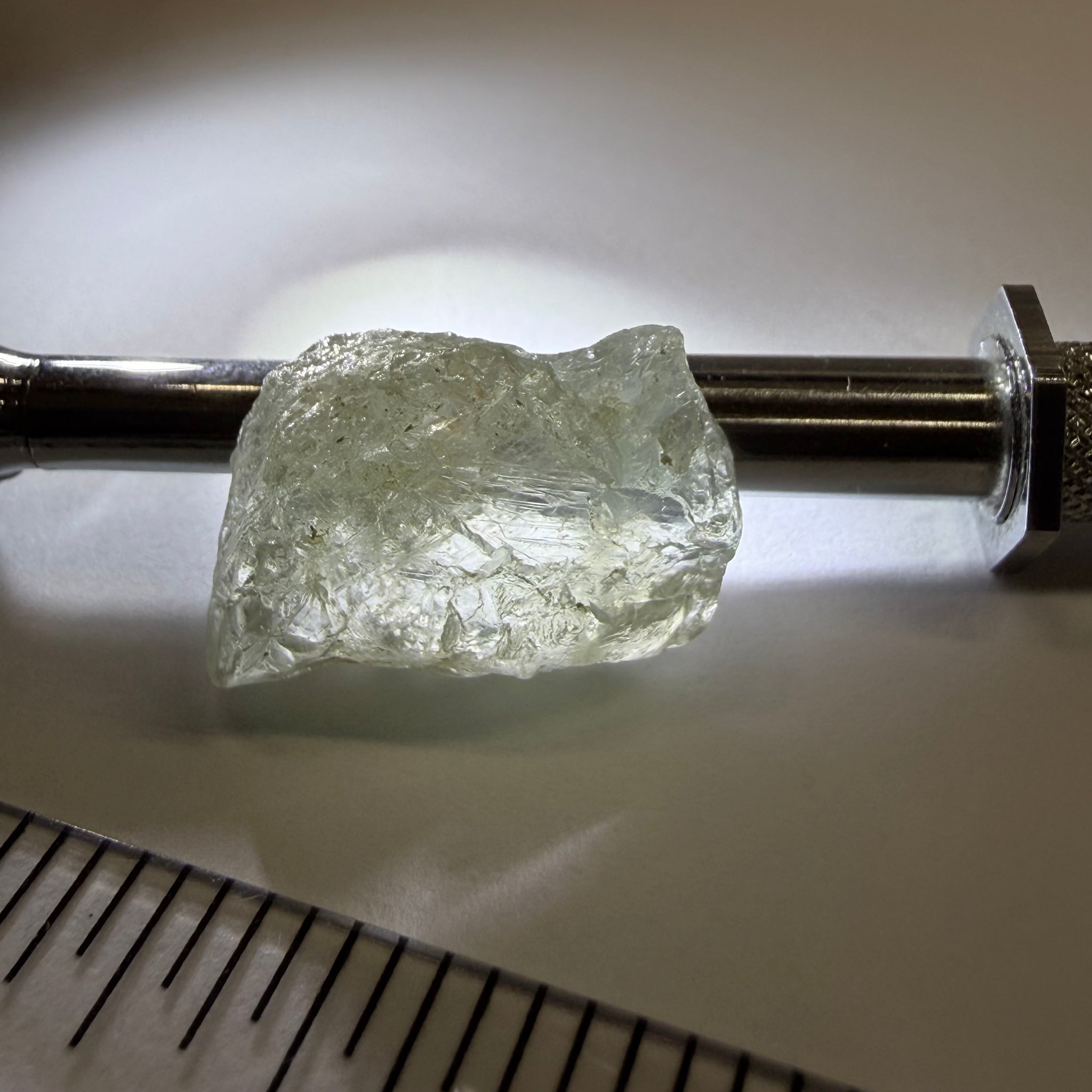 Umba Sapphire, 21.93ct, Umba, Tanzania, Untreated Unheated, flattish shape, moderate to heavy inclusions on the outside with a transparent needled, slightly included center, see the backlit photos