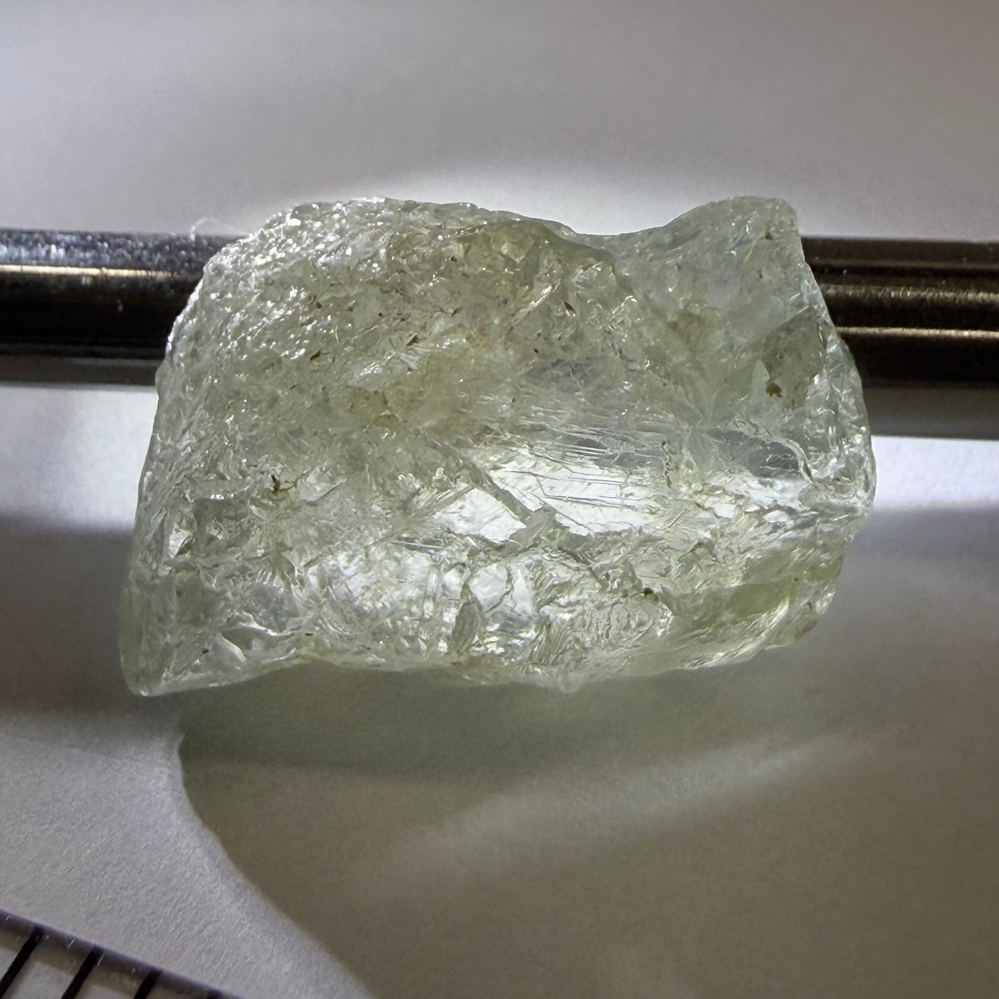 Umba Sapphire, 21.93ct, Umba, Tanzania, Untreated Unheated, flattish shape, moderate to heavy inclusions on the outside with a transparent needled, slightly included center, see the backlit photos
