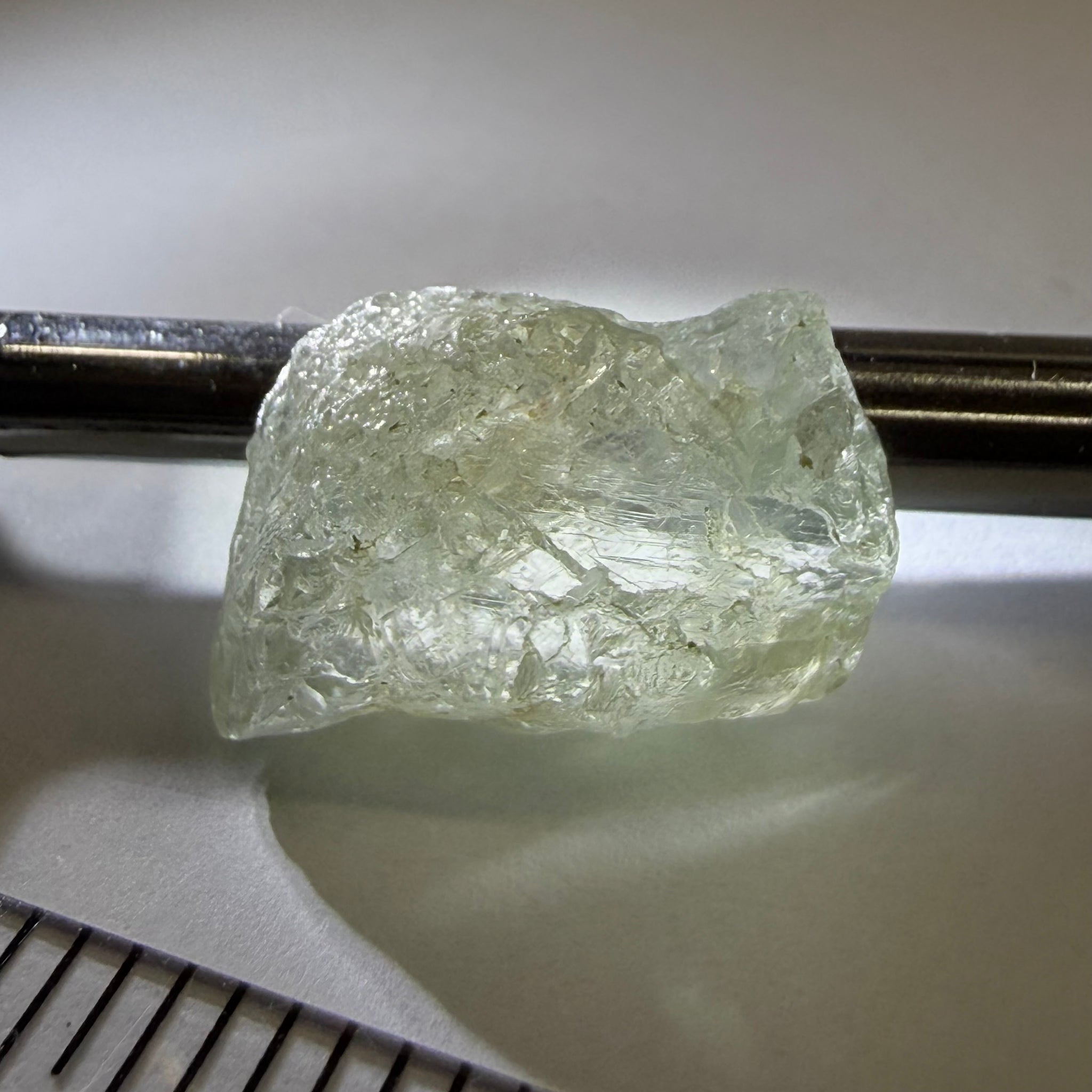 Umba Sapphire, 21.93ct, Umba, Tanzania, Untreated Unheated, flattish shape, moderate to heavy inclusions on the outside with a transparent needled, slightly included center, see the backlit photos