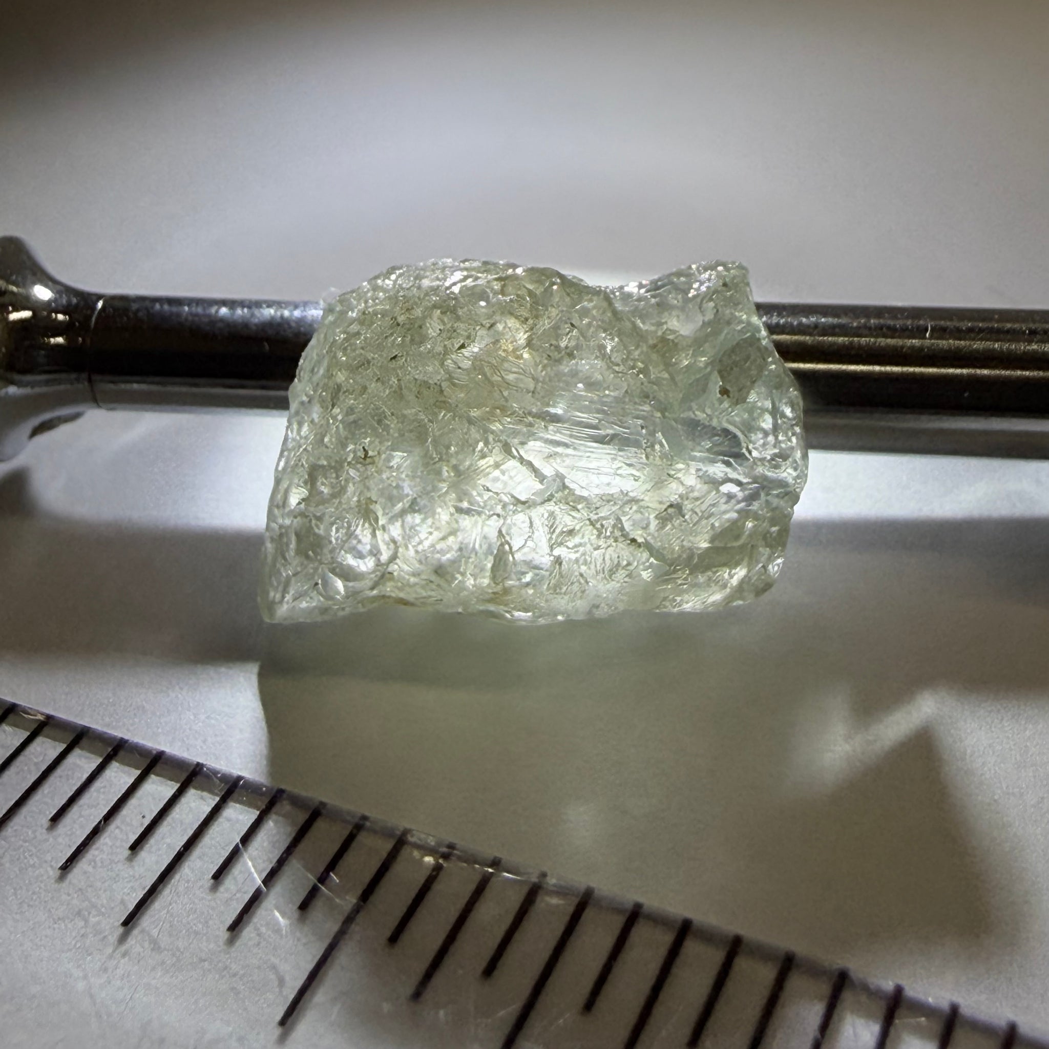 Umba Sapphire, 21.93ct, Umba, Tanzania, Untreated Unheated, flattish shape, moderate to heavy inclusions on the outside with a transparent needled, slightly included center, see the backlit photos