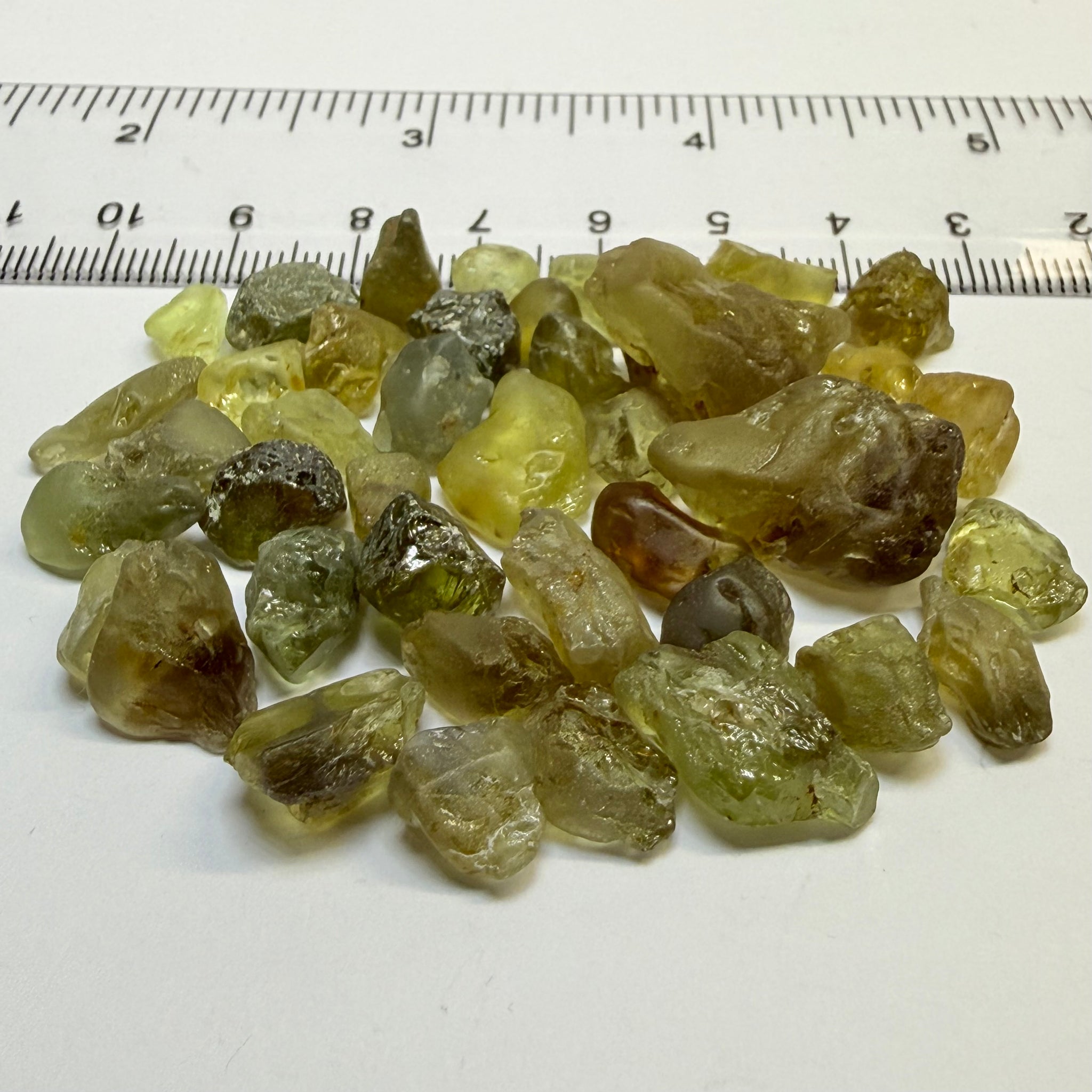 Chrysoberyl lot, 190.09ct, Tunduru, Tanzania, Untreated Unheated. A mix between faceting grade and cabbing grade rough, they change colour but only very very slightly, see video showing the different lights