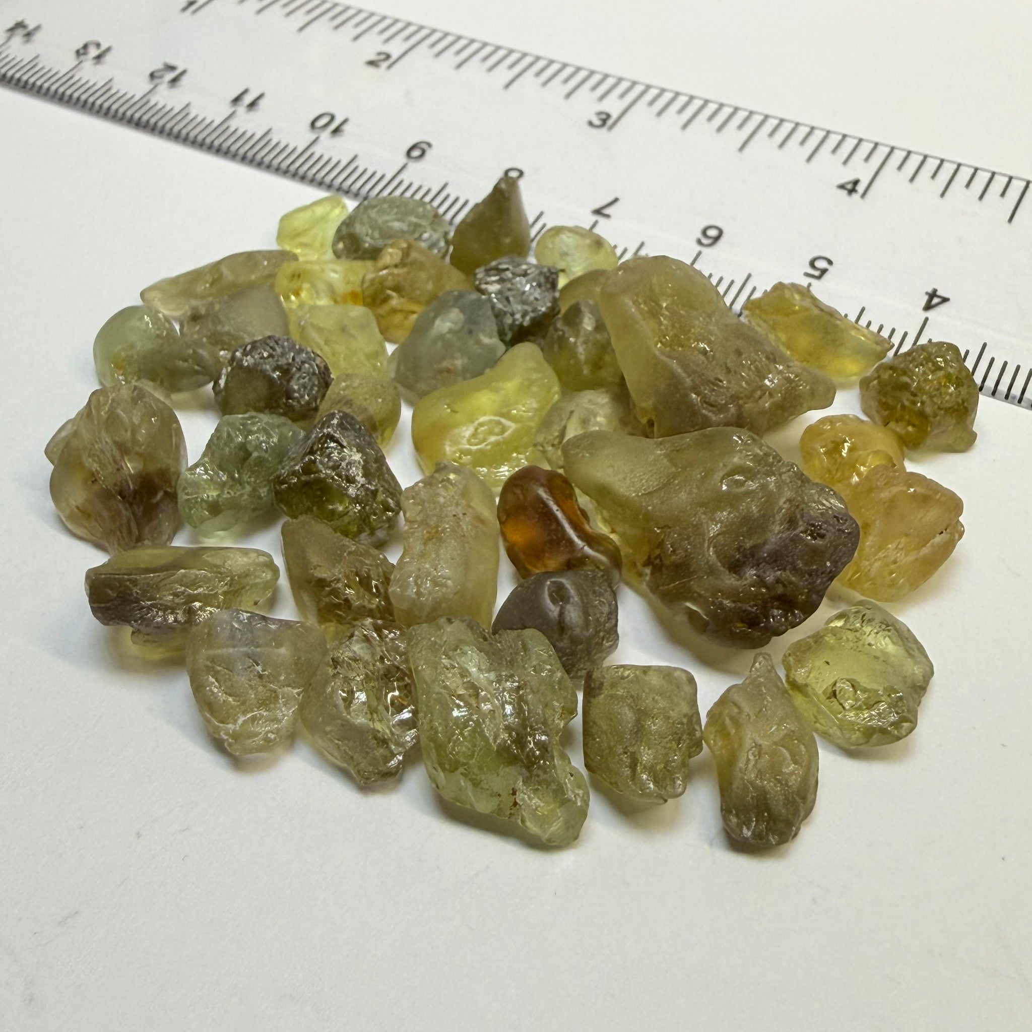 Chrysoberyl lot, 190.09ct, Tunduru, Tanzania, Untreated Unheated. A mix between faceting grade and cabbing grade rough, they change colour but only very very slightly, see video showing the different lights