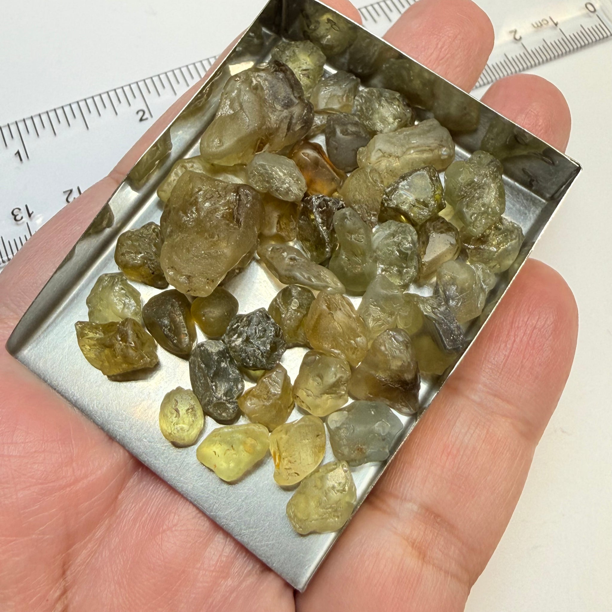 Chrysoberyl lot, 190.09ct, Tunduru, Tanzania, Untreated Unheated. A mix between faceting grade and cabbing grade rough, they change colour but only very very slightly, see video showing the different lights