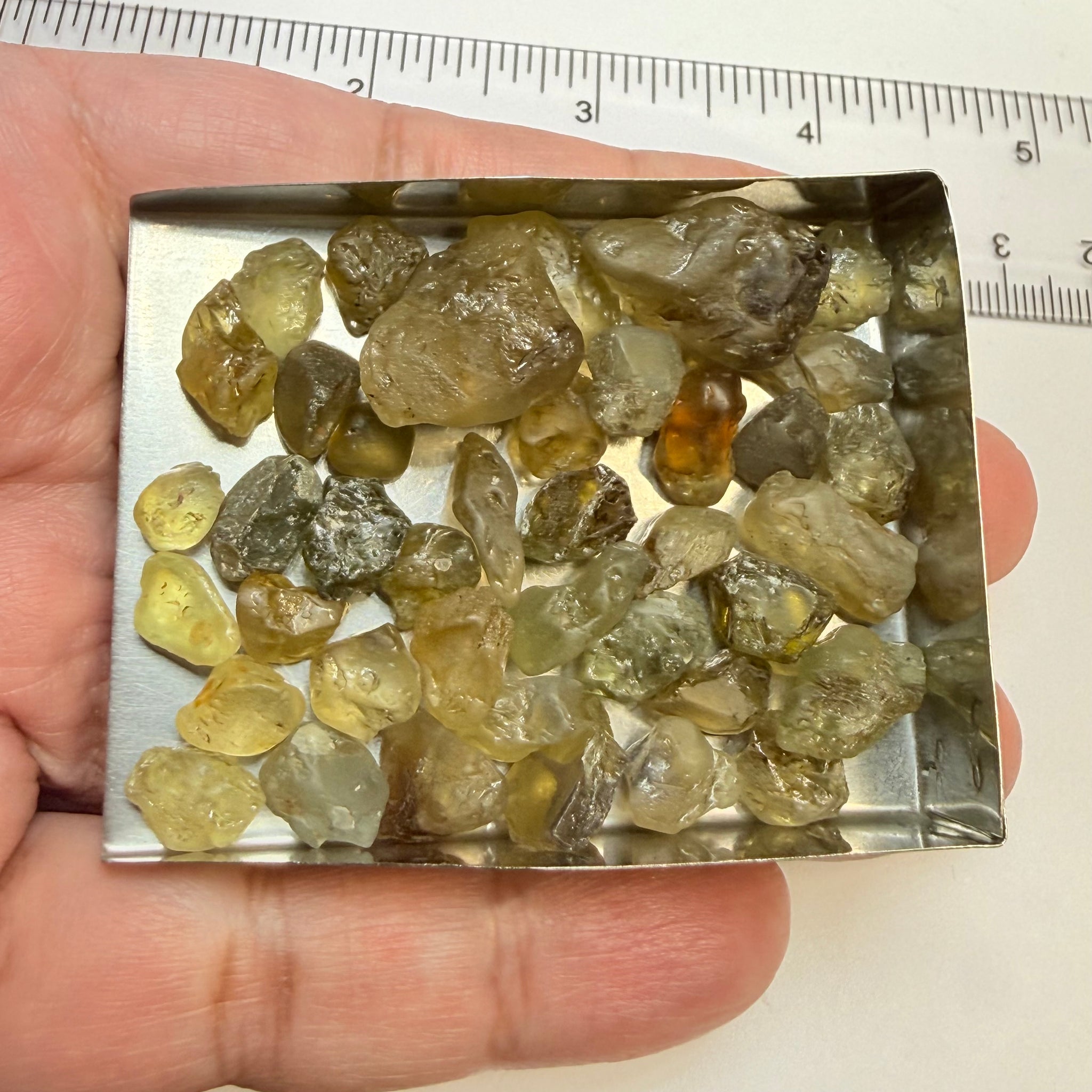 Chrysoberyl lot, 190.09ct, Tunduru, Tanzania, Untreated Unheated. A mix between faceting grade and cabbing grade rough, they change colour but only very very slightly, see video showing the different lights