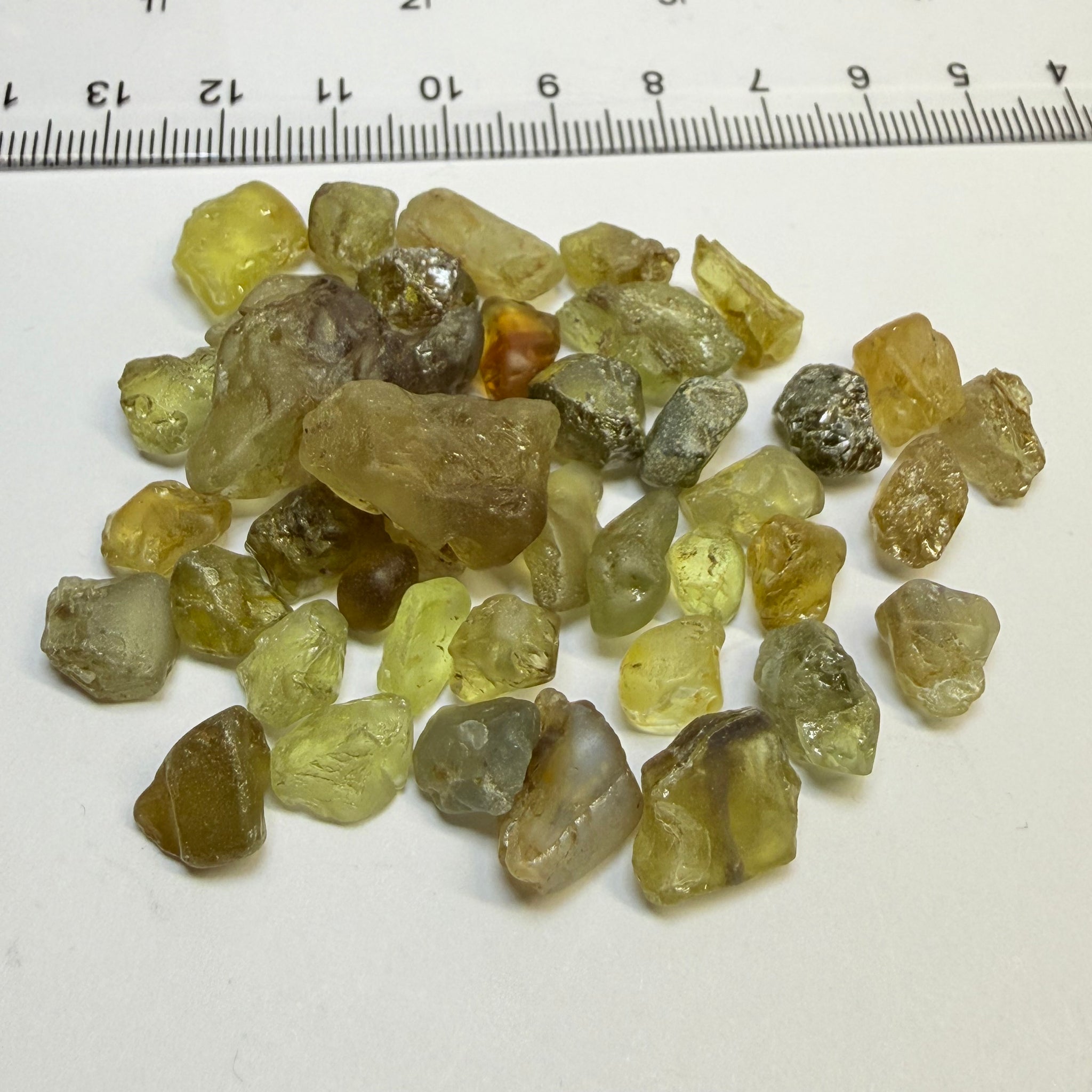 Chrysoberyl lot, 190.09ct, Tunduru, Tanzania, Untreated Unheated. A mix between faceting grade and cabbing grade rough, they change colour but only very very slightly, see video showing the different lights