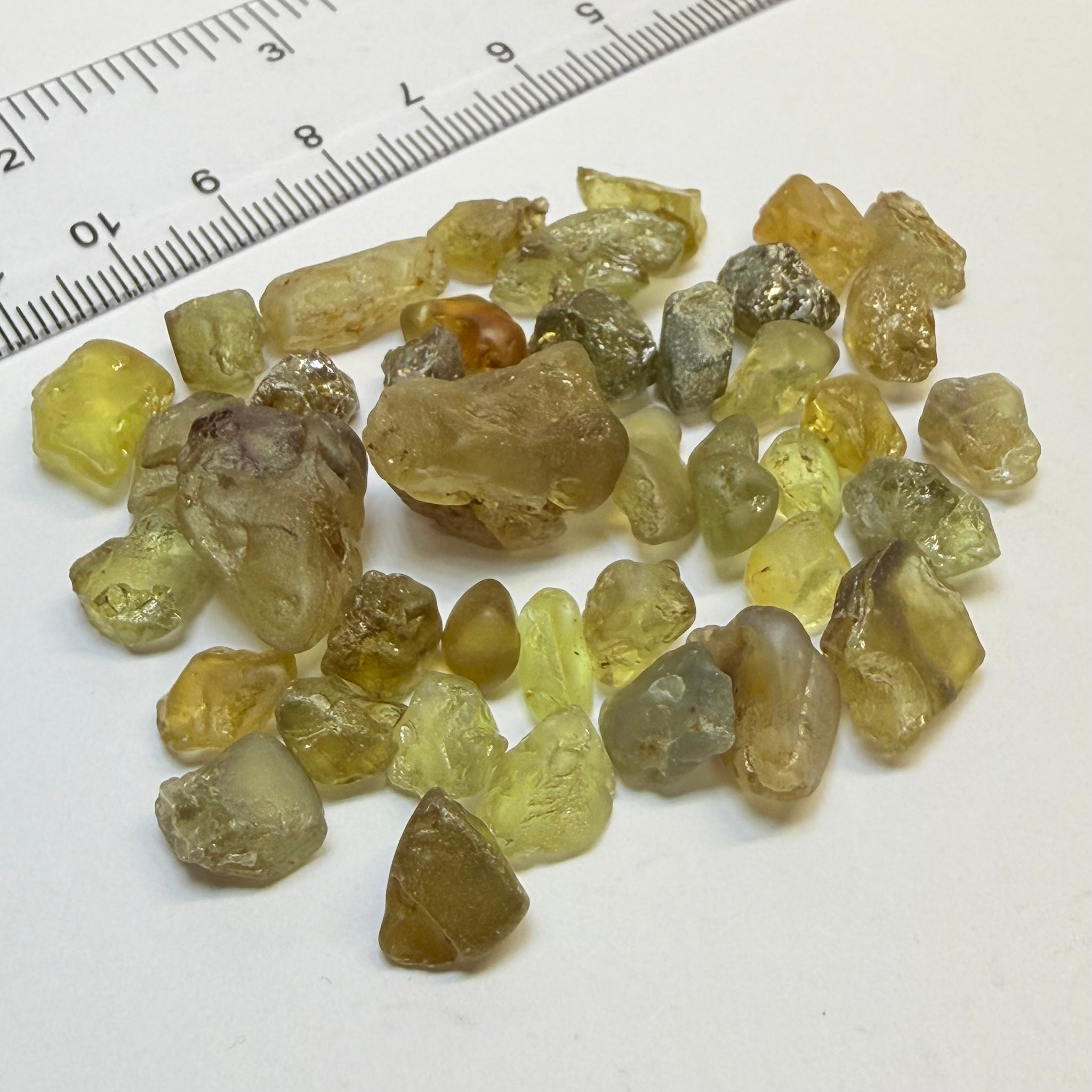 Chrysoberyl lot, 190.09ct, Tunduru, Tanzania, Untreated Unheated. A mix between faceting grade and cabbing grade rough, they change colour but only very very slightly, see video showing the different lights