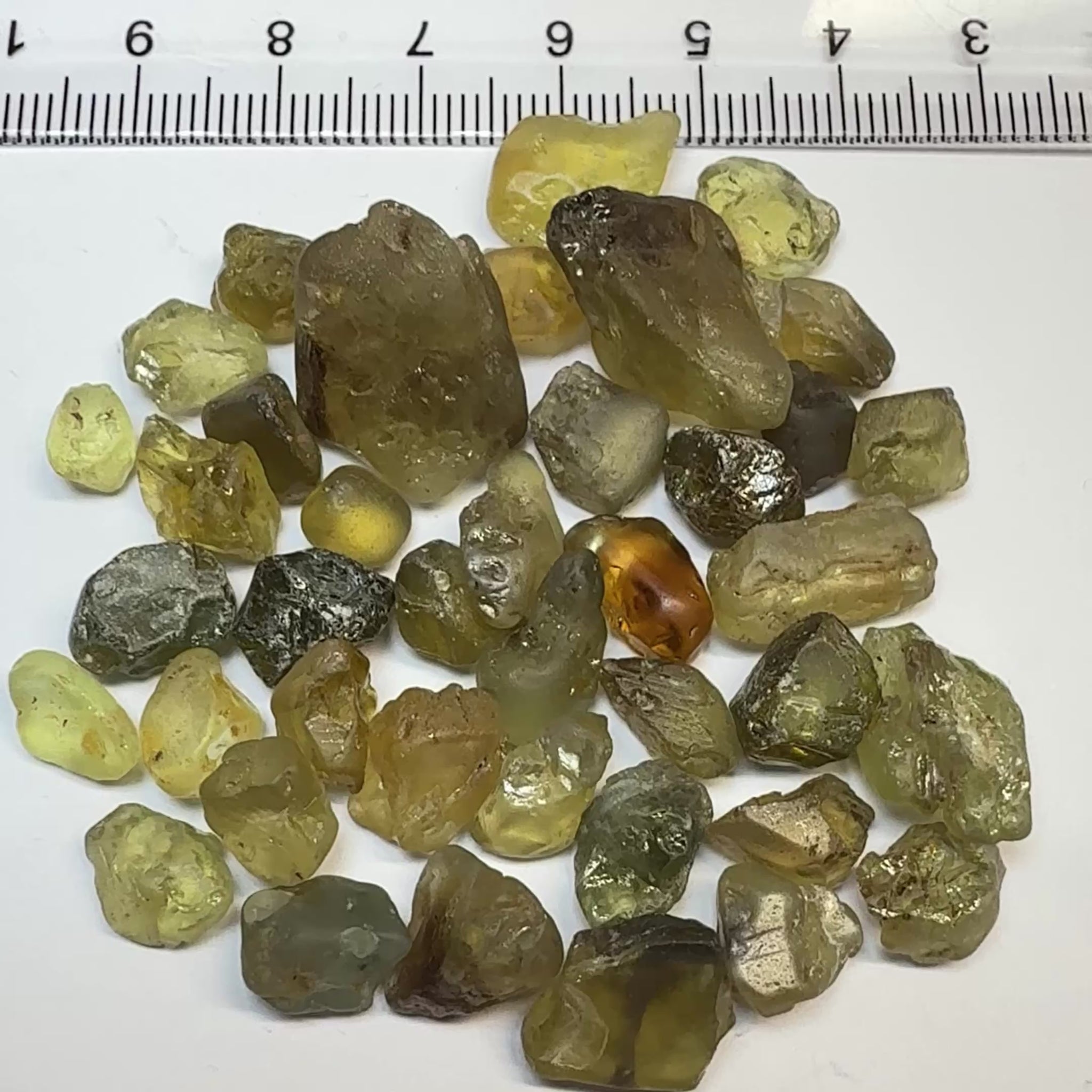 Chrysoberyl lot, 190.09ct, Tunduru, Tanzania, Untreated Unheated. A mix between faceting grade and cabbing grade rough, they change colour but only very very slightly, see video showing the different lights